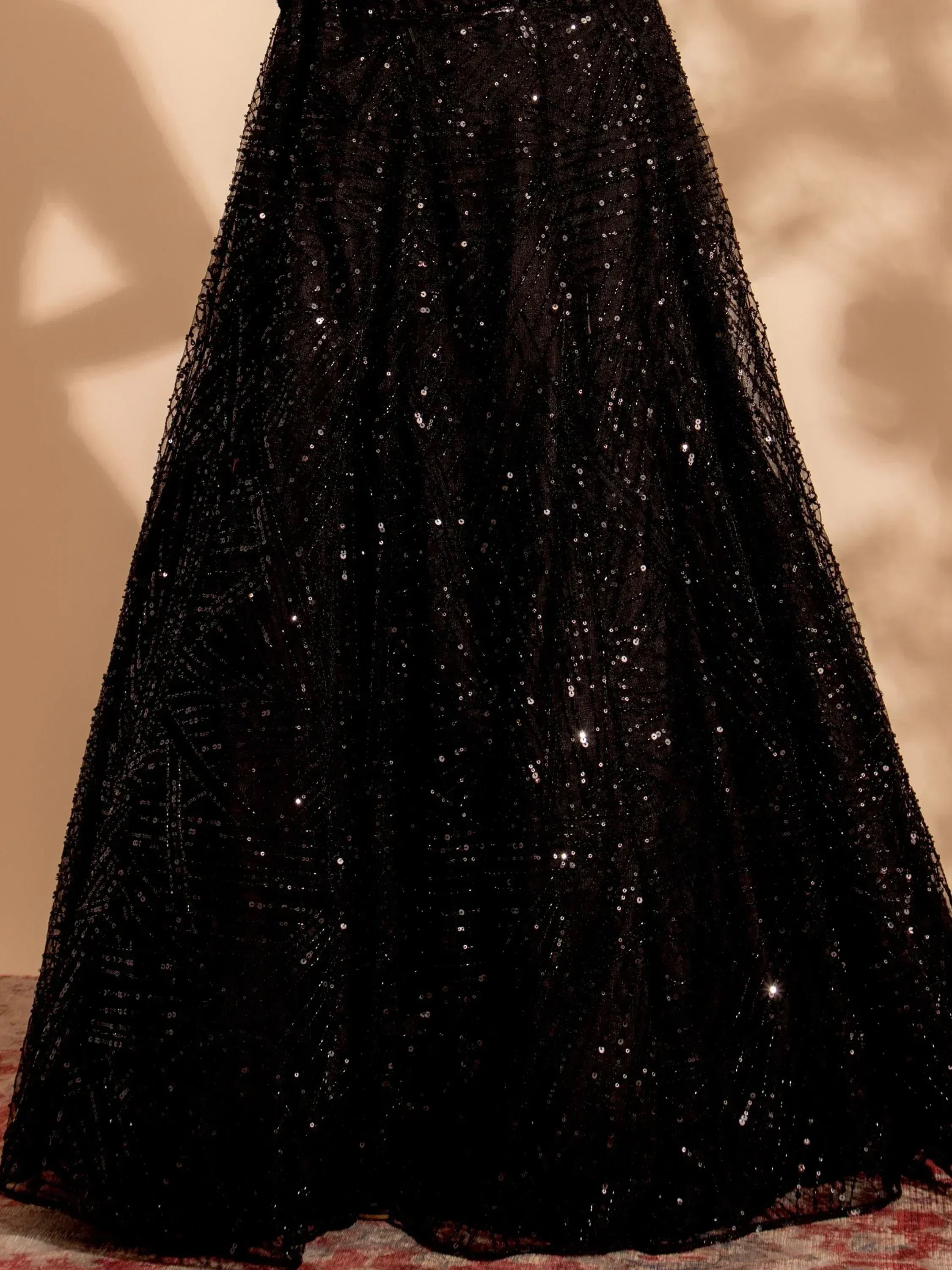 Black sequin ethnic gown with shimmering details, perfect for festive occasions and evening wear.