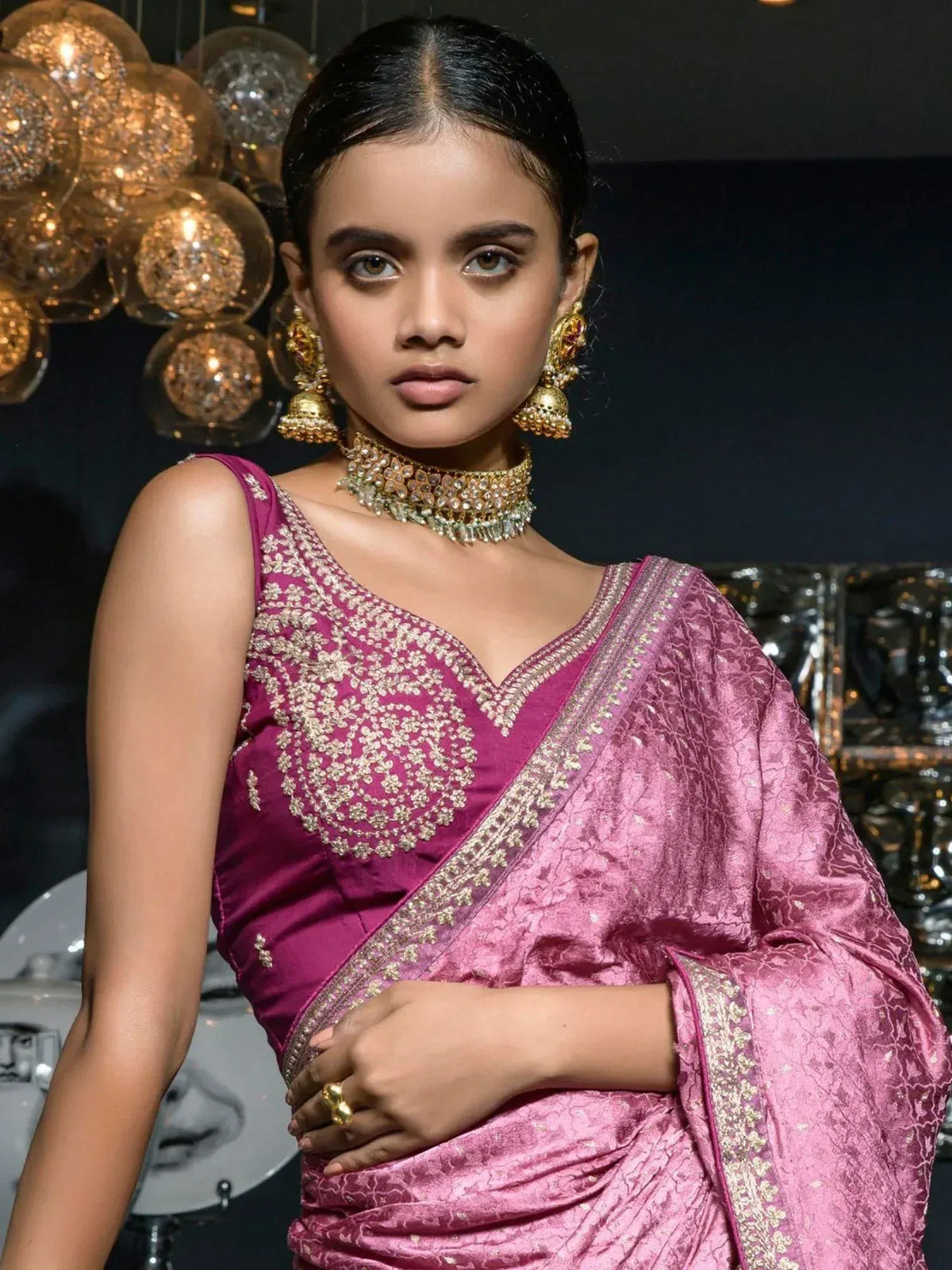 Pink embroidered saree with gold jewelry, perfect for Indian ethnic wear occasions