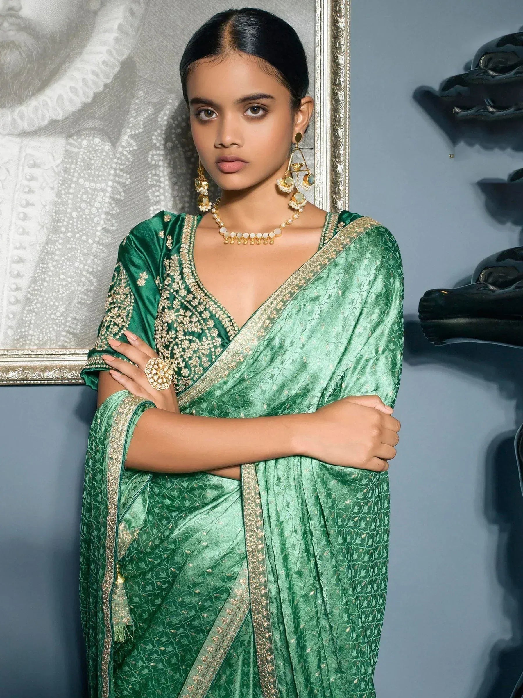 Emerald green designer saree with gold embroidery, perfect for Indian ethnic wear and festive occasions.