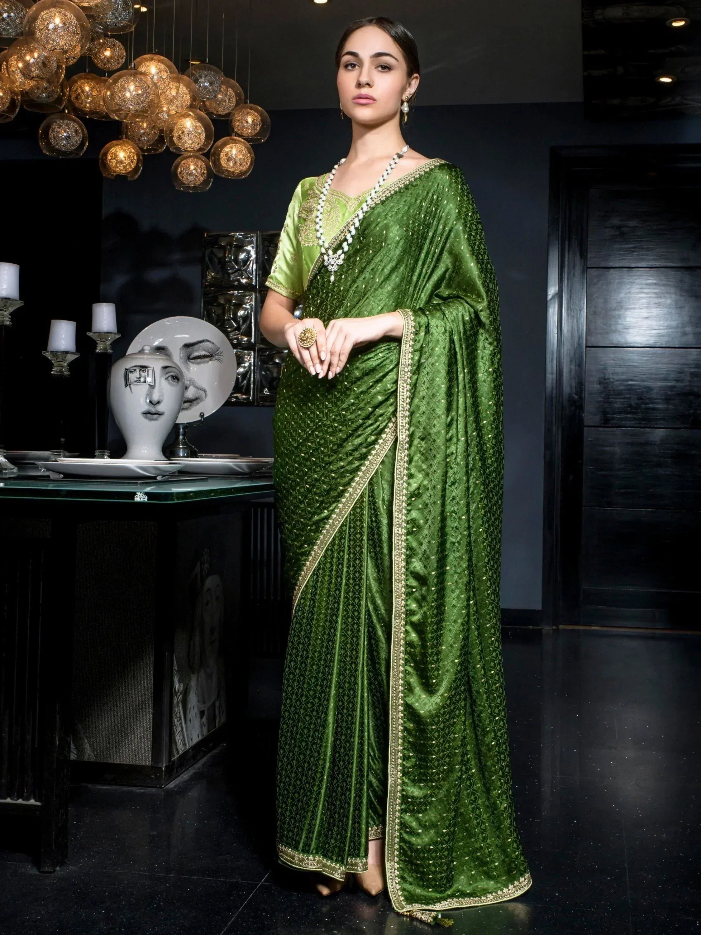 Elegant green velvet saree with gold embroidery, perfect for Indian ethnic wear and festive occasions.