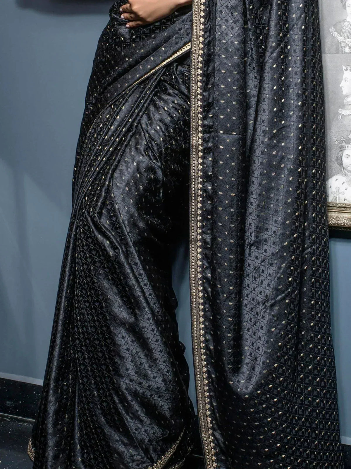 Black designer saree with gold embroidery and intricate patterns, perfect for ethnic wear occasions.