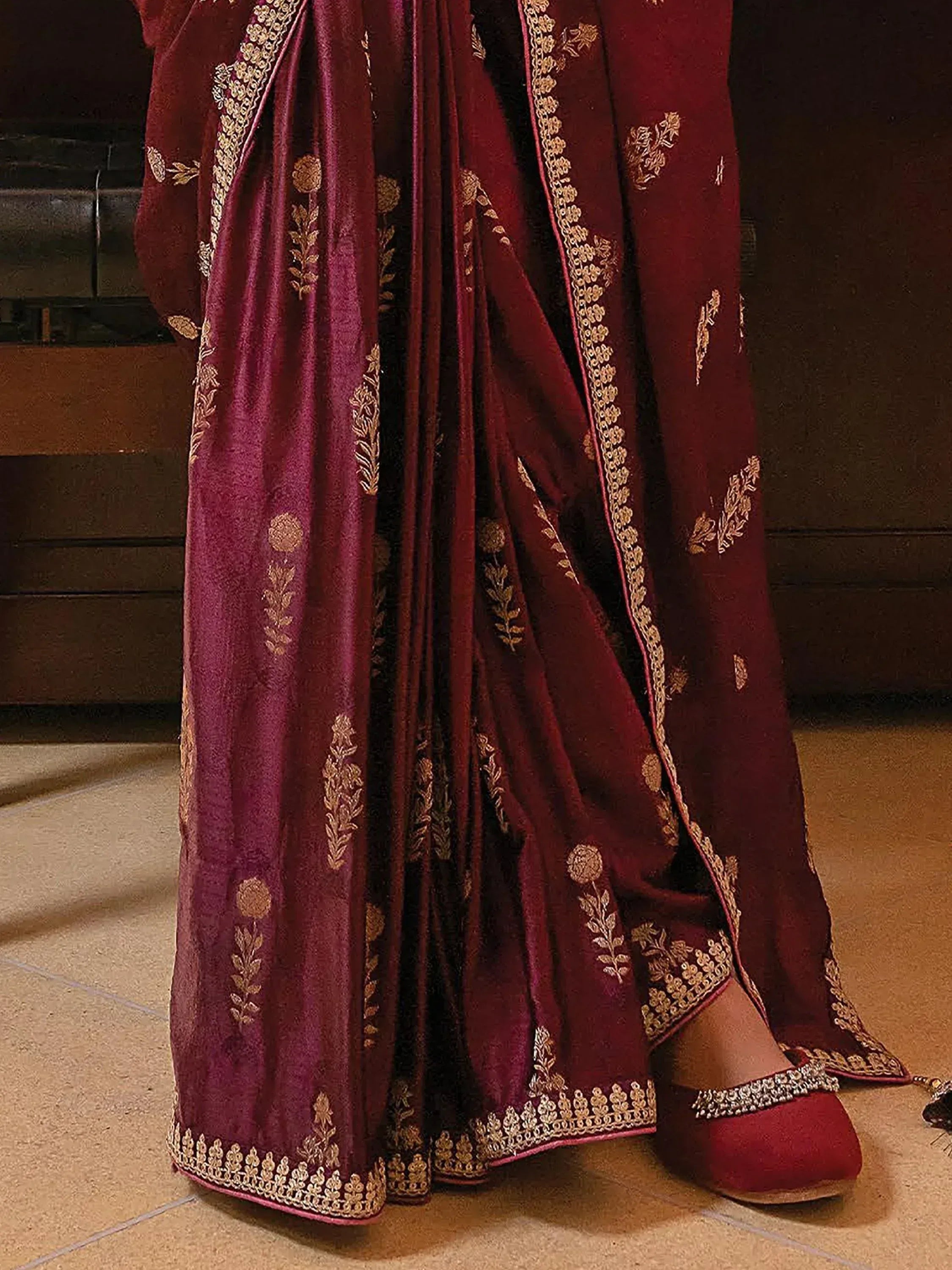 Maroon velvet lehenga with gold floral embroidery and matching embellished shoes