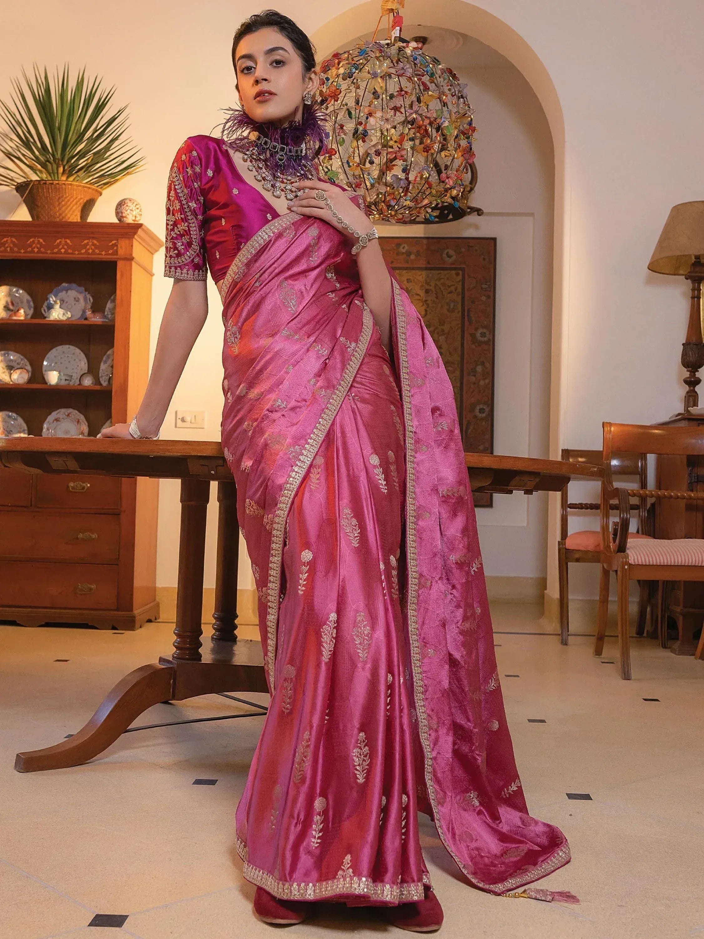 Woman in elegant pink silk saree with gold embroidery, perfect for Indian ethnic wear occasions