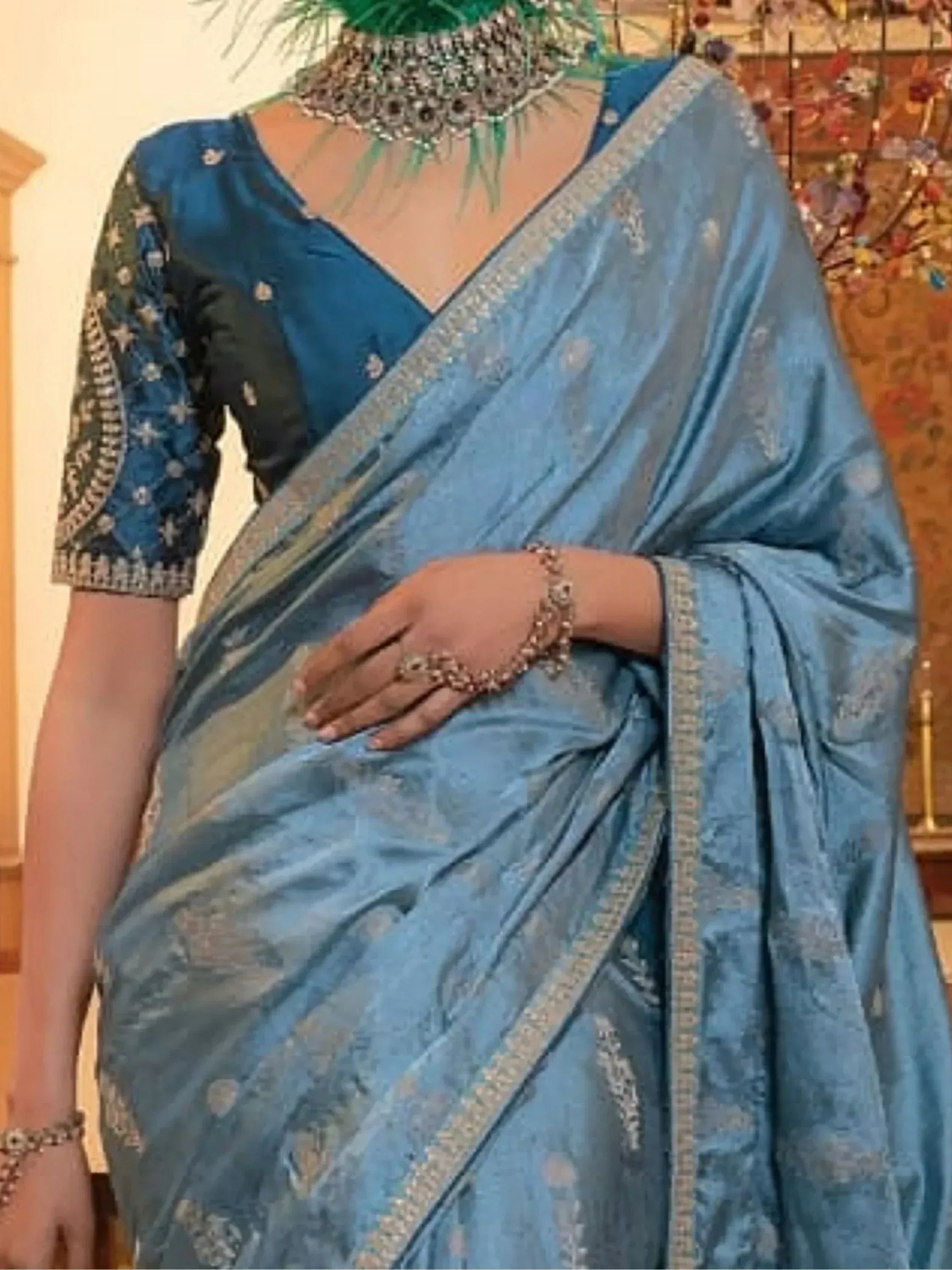 Blue designer saree with embroidered blouse and peacock feather jewelry, ethnic Indian wear
