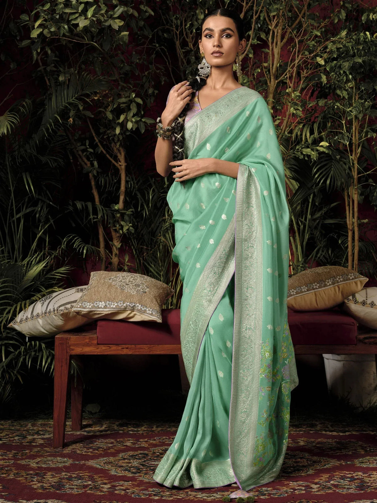 Mint green designer saree with silver zari border and floral motifs, perfect for Indian ethnic occasions