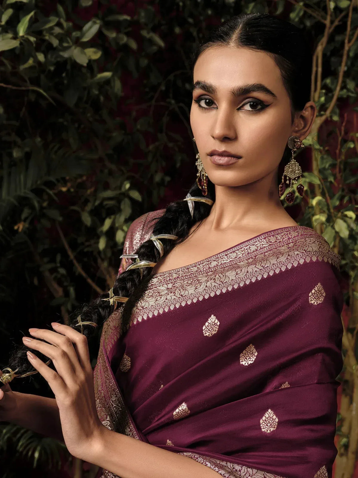 Woman in maroon ethnic saree with gold embroidery, traditional Indian wear for festive occasions