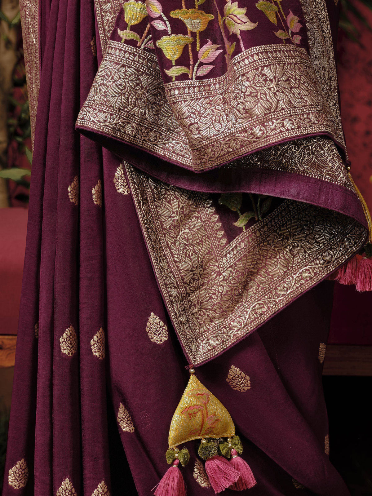 Purple Indian ethnic saree with gold floral embroidery and tassels, perfect for festive occasions.