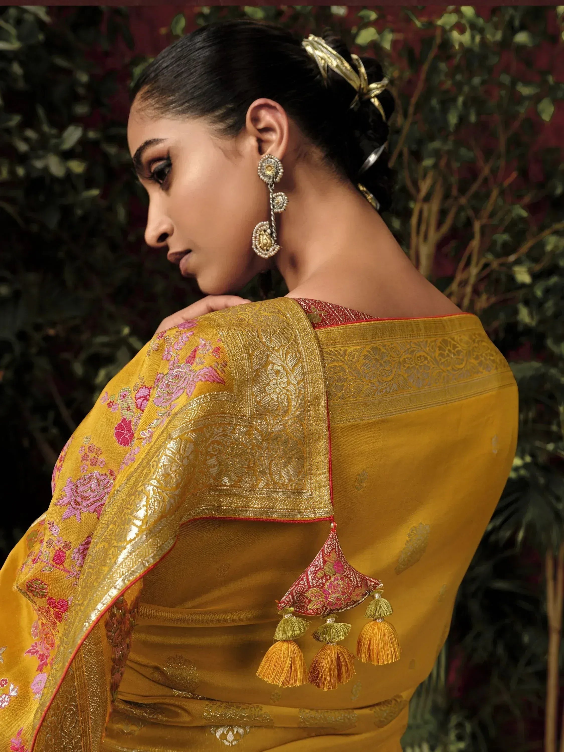 Yellow designer saree with pink floral embroidery and gold zari border, perfect for ethnic occasions