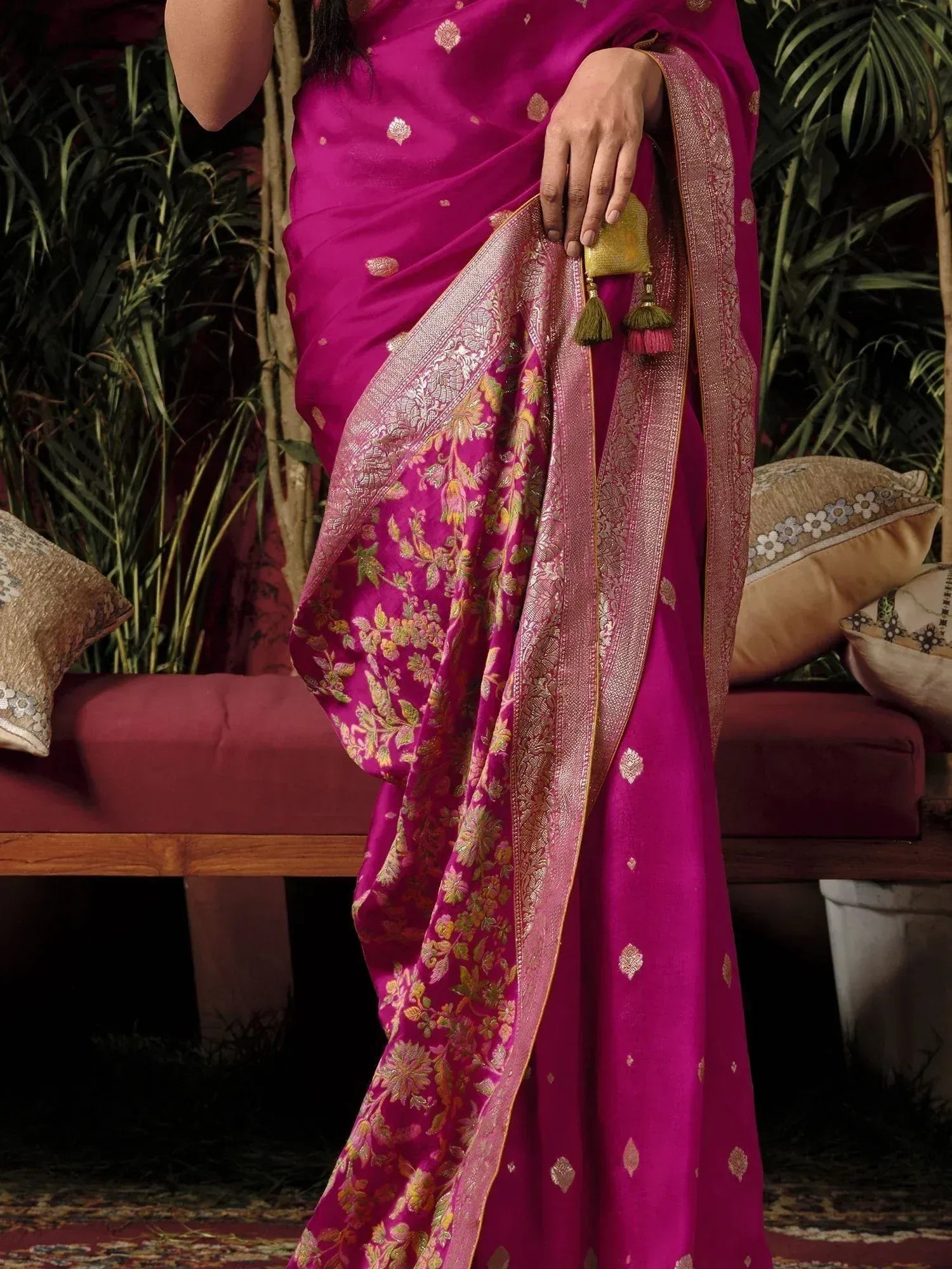 Fuchsia silk saree with gold floral zari border and tassels, perfect for Indian ethnic occasions