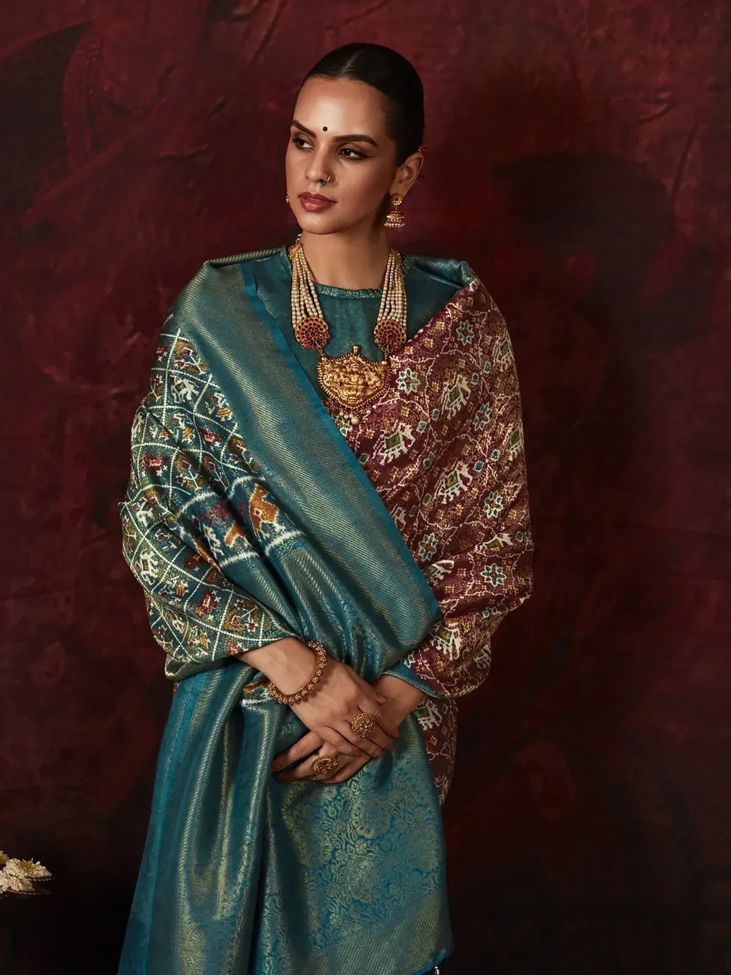 Teal and maroon embroidered saree with gold jewelry, Indian ethnic wear for festive occasions