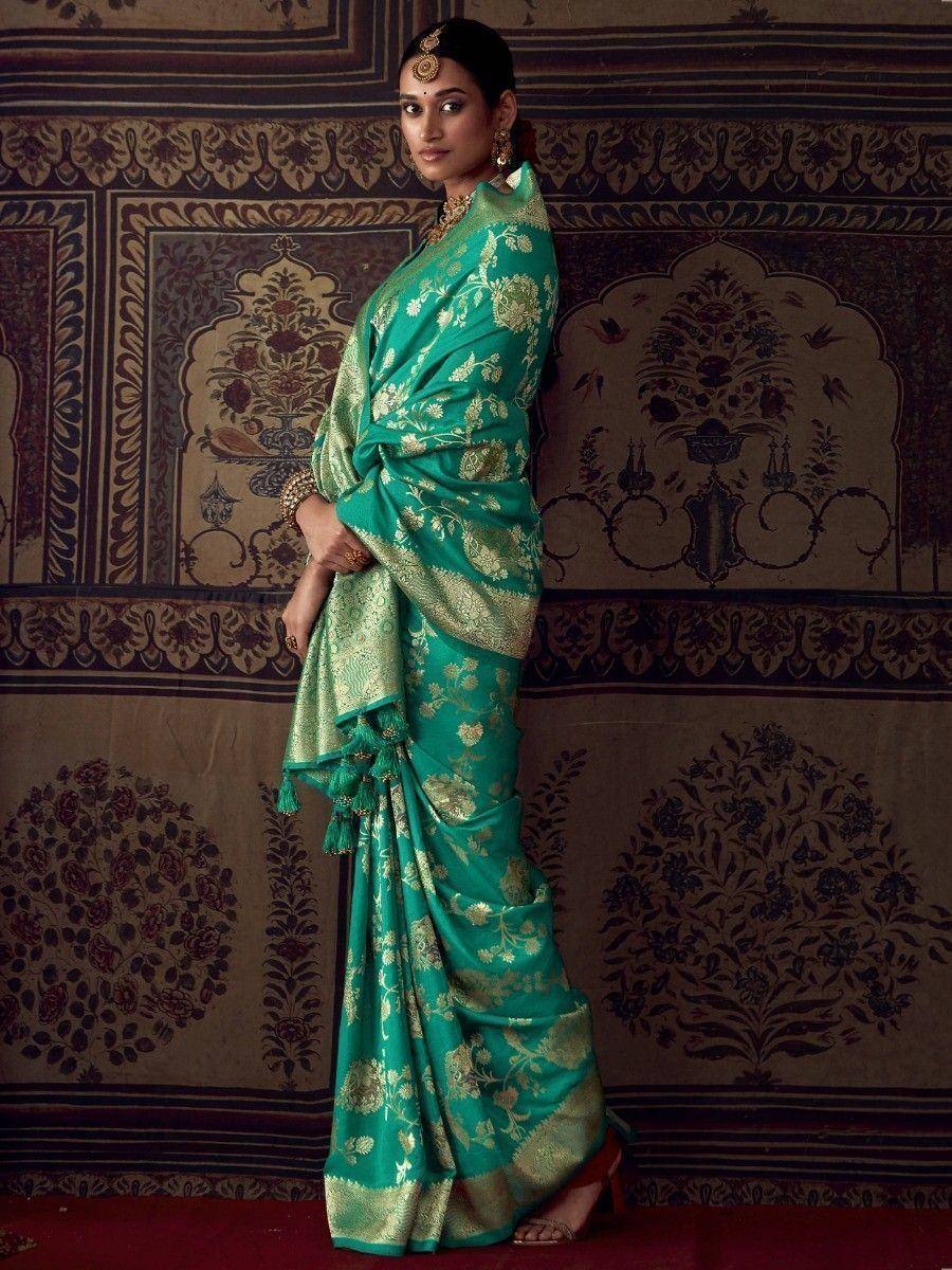 Emerald green designer saree with gold floral embroidery, perfect for Indian ethnic wear occasions