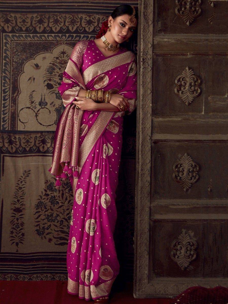 Elegant pink saree with gold motifs and polka dots, styled with traditional jewelry for Indian ethnic wear.