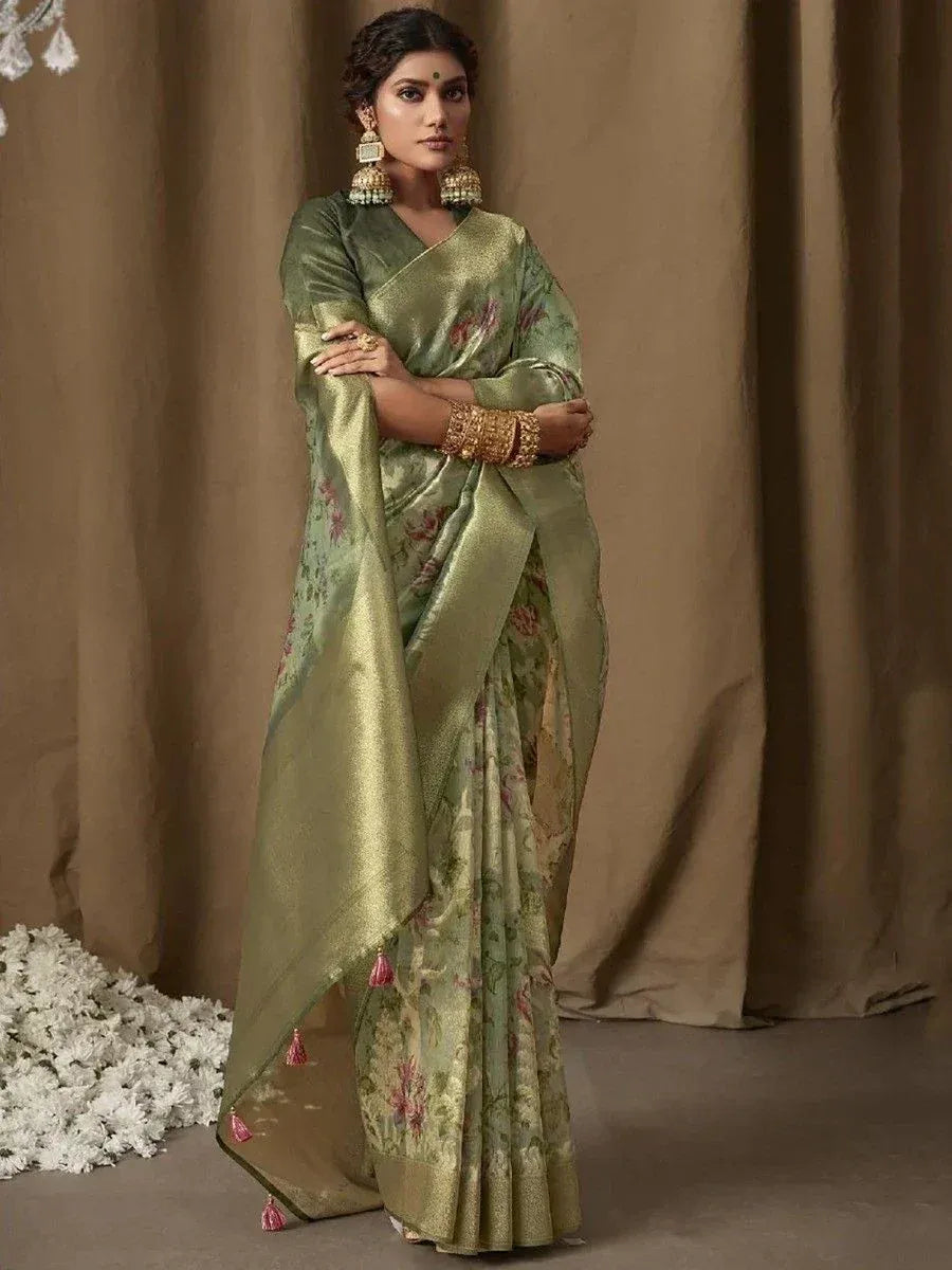 Olive green floral saree with gold border and tassels, styled with traditional Indian jewelry for ethnic wear