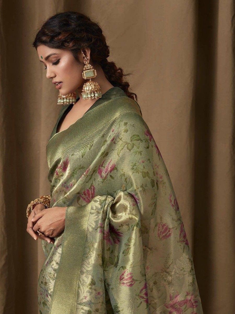 Woman in olive green floral saree with gold jewelry, ethnic Indian wear