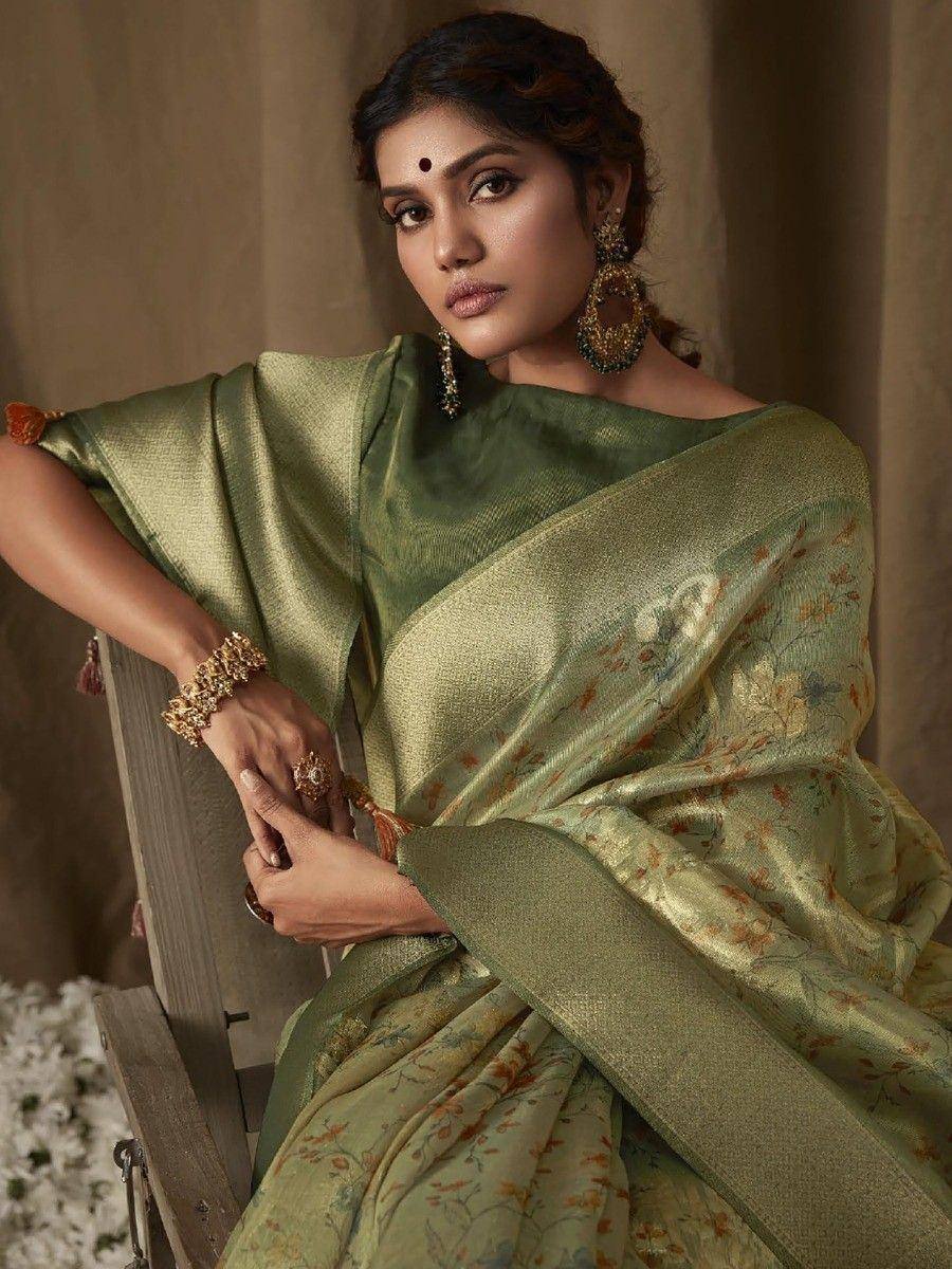 Elegant olive green floral saree with gold embroidery, styled with traditional jewelry for Indian ethnic wear