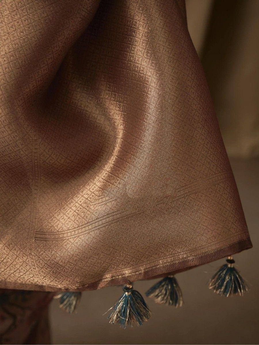 Brown ethnic saree with blue tassels and woven texture, perfect for Indian occasions