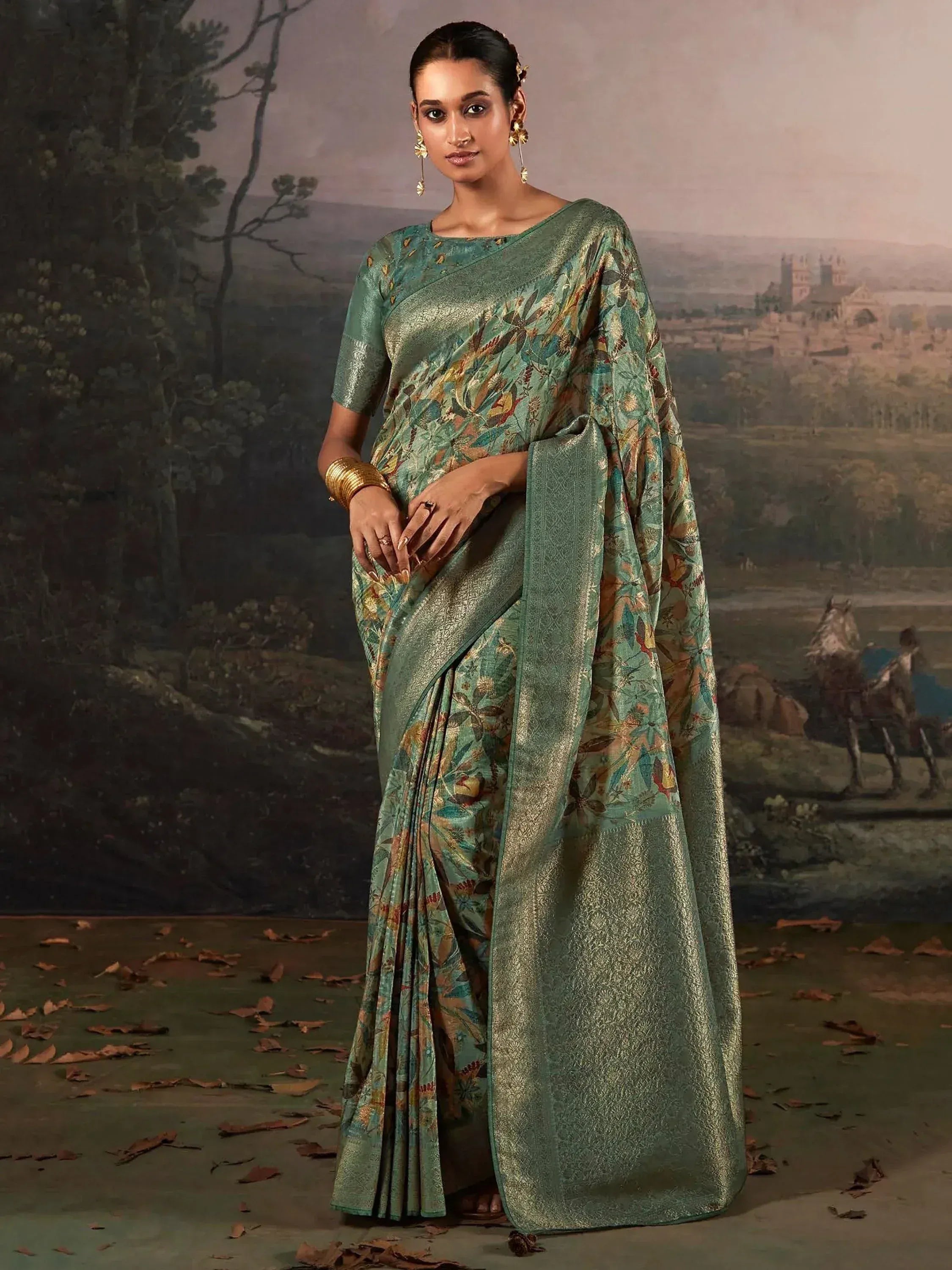Elegant green floral print saree with gold zari border, perfect for Indian ethnic occasions