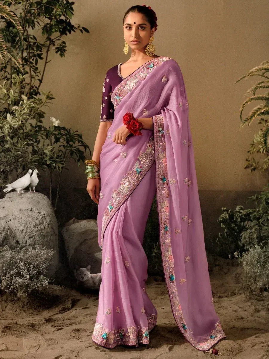 Lavender embroidered saree with purple blouse, floral border, and traditional Indian jewelry for ethnic wear