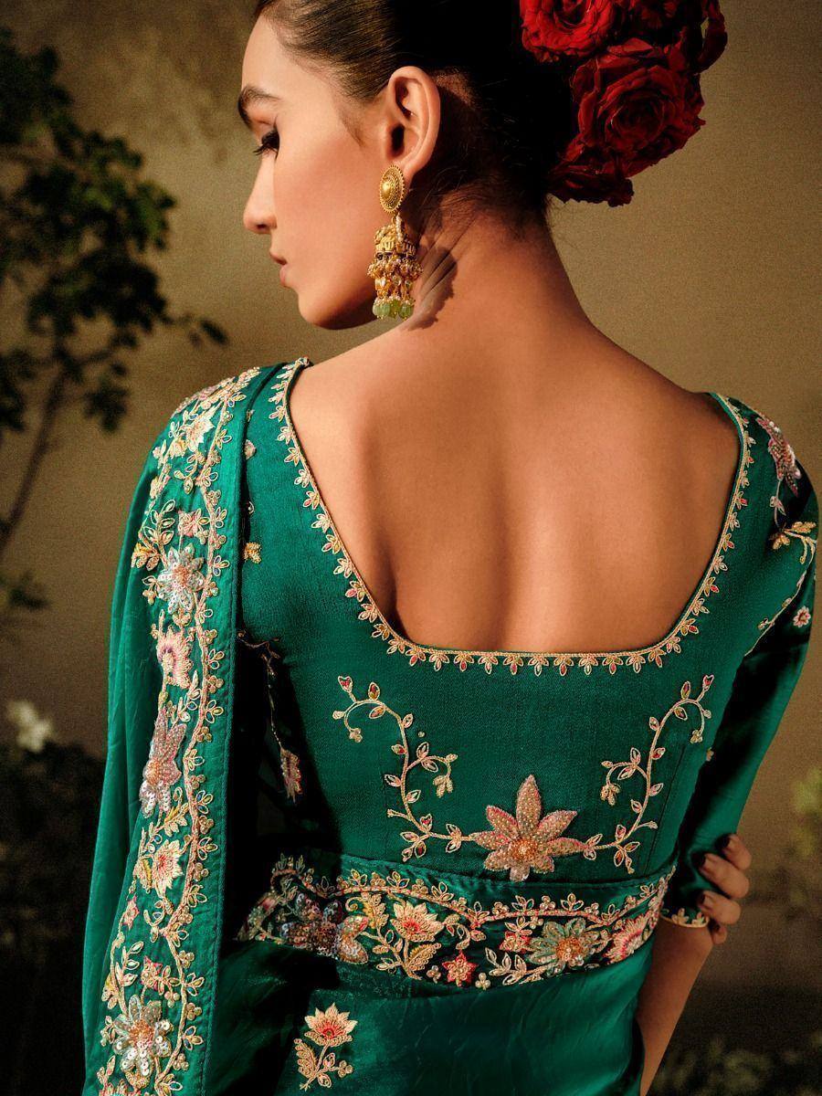 Emerald green designer lehenga choli with floral embroidery and open back, perfect for Indian ethnic wear.