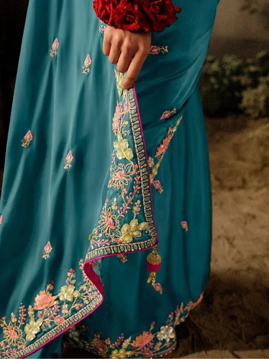 Teal embroidered lehenga choli with floral motifs and pink border, perfect for Indian ethnic wear