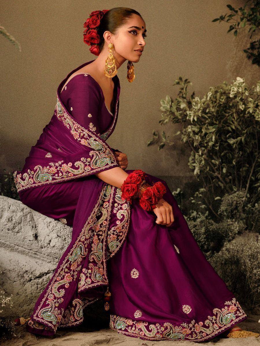 Elegant purple designer saree with intricate paisley embroidery and red floral accents