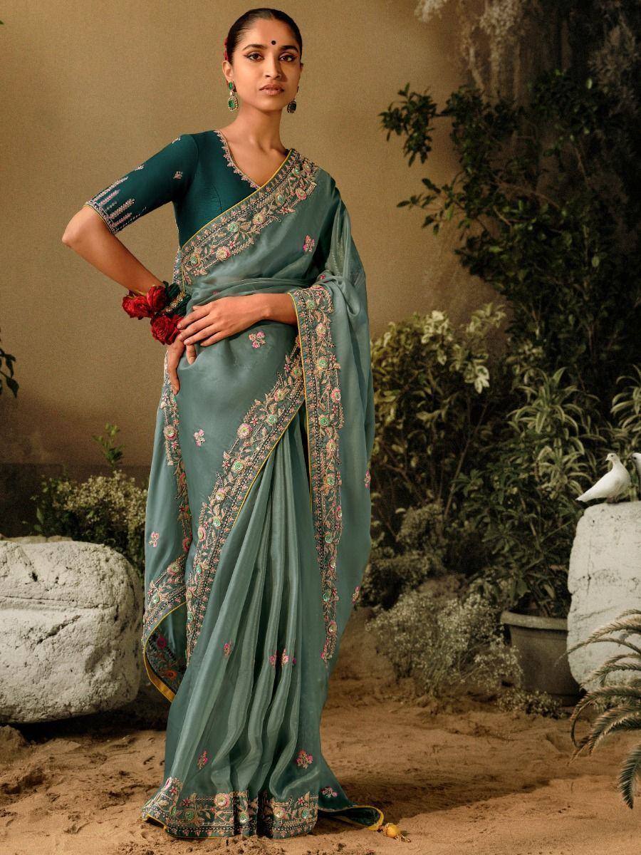 Elegant teal saree with floral embroidery, perfect for Indian ethnic wear occasions.