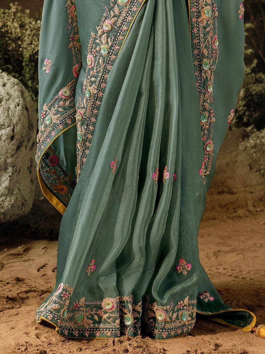 Elegant teal saree with floral embroidery and golden border, perfect for ethnic occasions