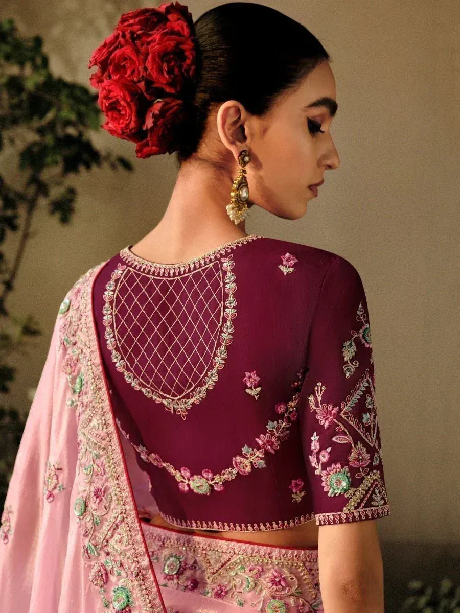 Elegant maroon embroidered blouse with floral back design, paired with pink lehenga, styled with red rose hair accessory