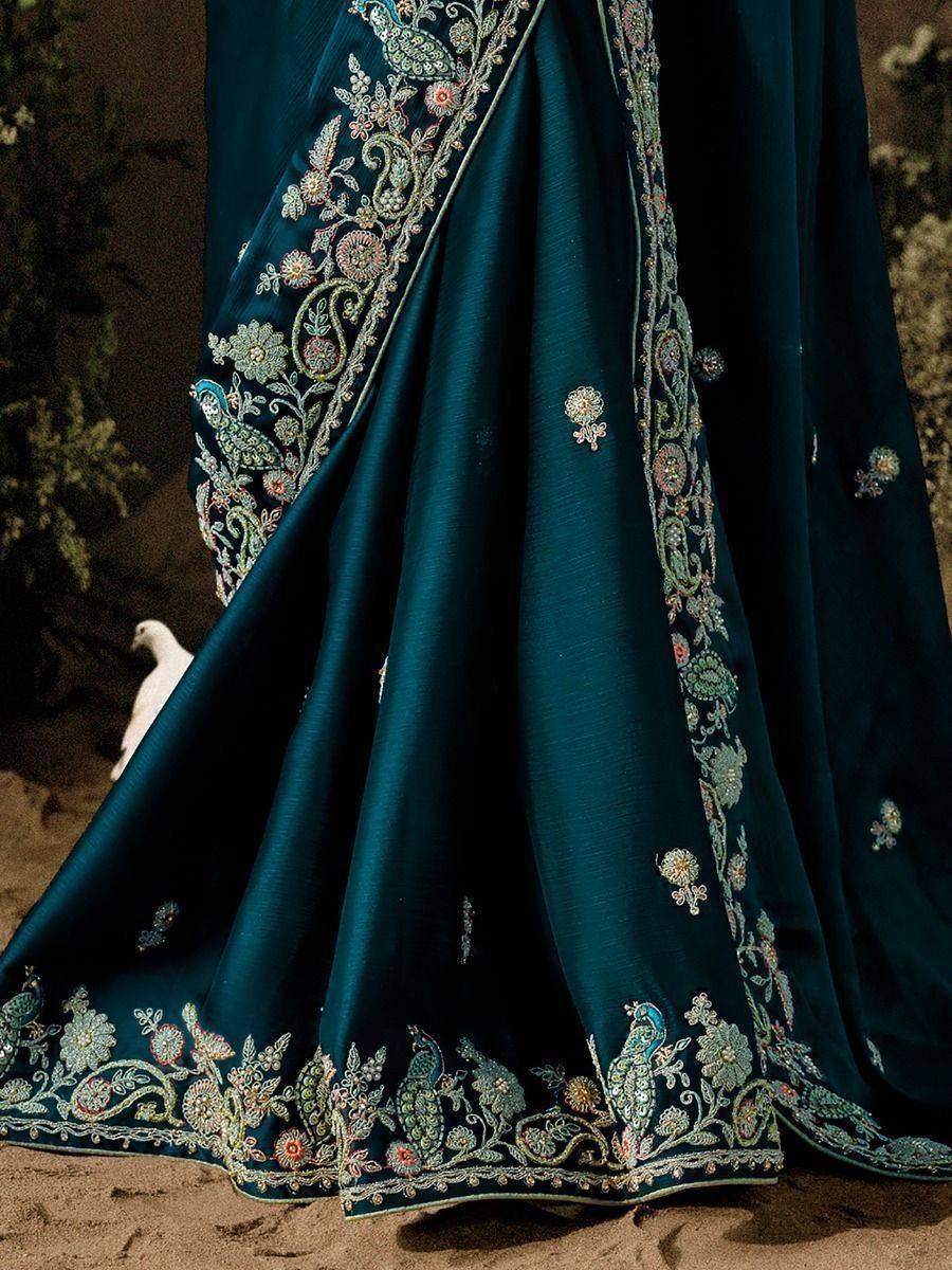 Teal saree with intricate floral and peacock embroidery, perfect for Indian ethnic wear occasions.