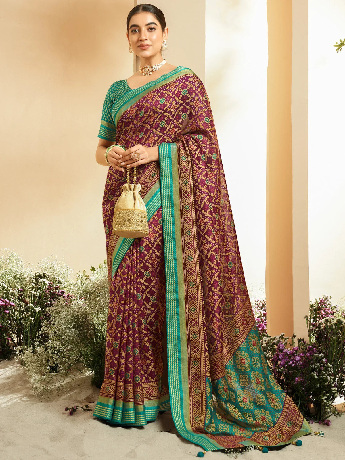 Elegant maroon and teal saree with intricate gold patterns, perfect for ethnic occasions.