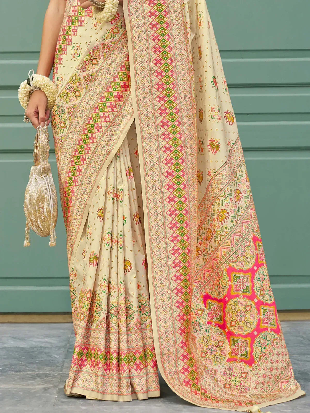 Cream saree with pink green geometric print, ethnic Indian wear, matching potli bag