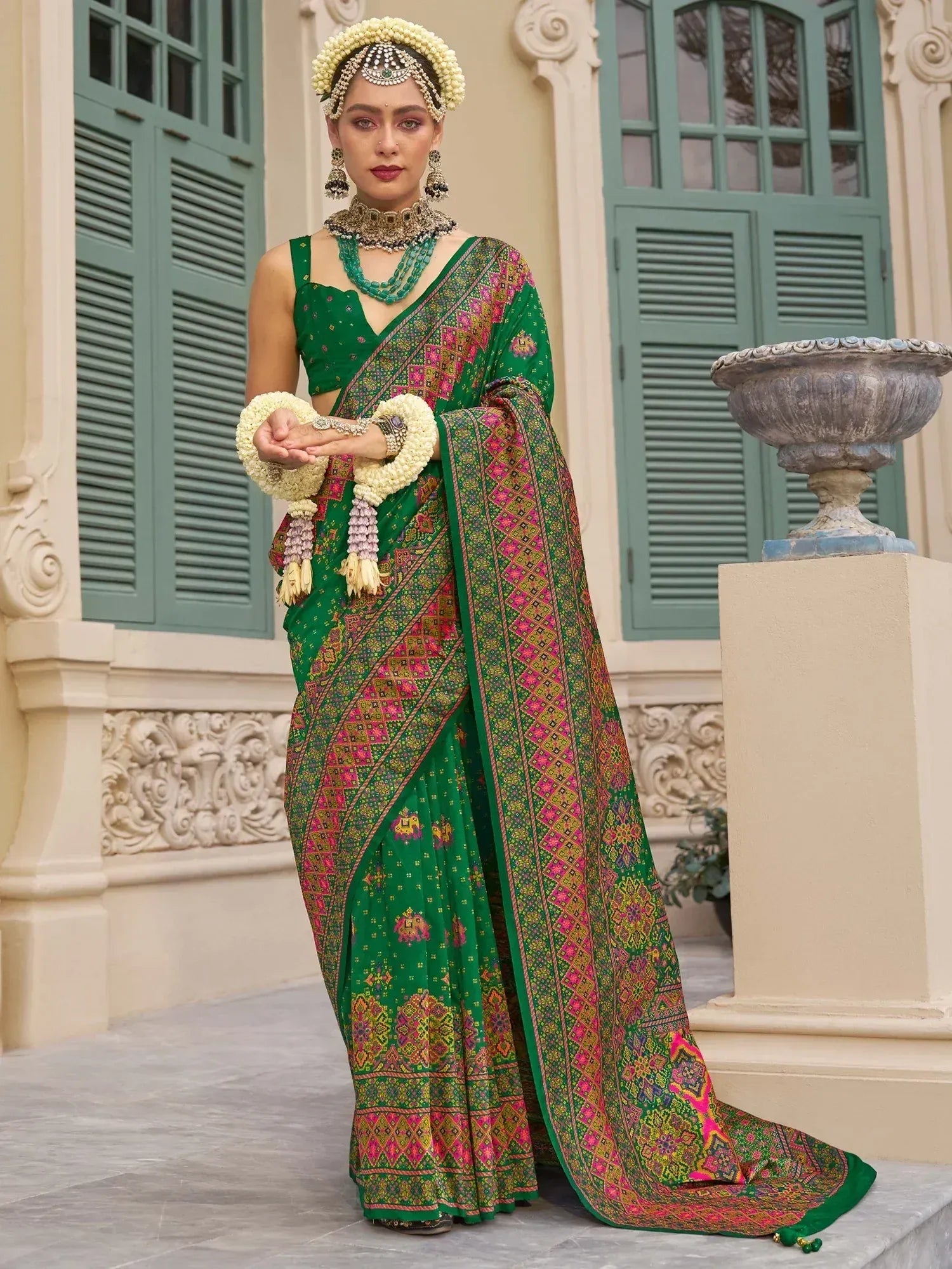 Green printed saree with pink gold motifs, traditional jewelry, floral headpiece, ethnic wear