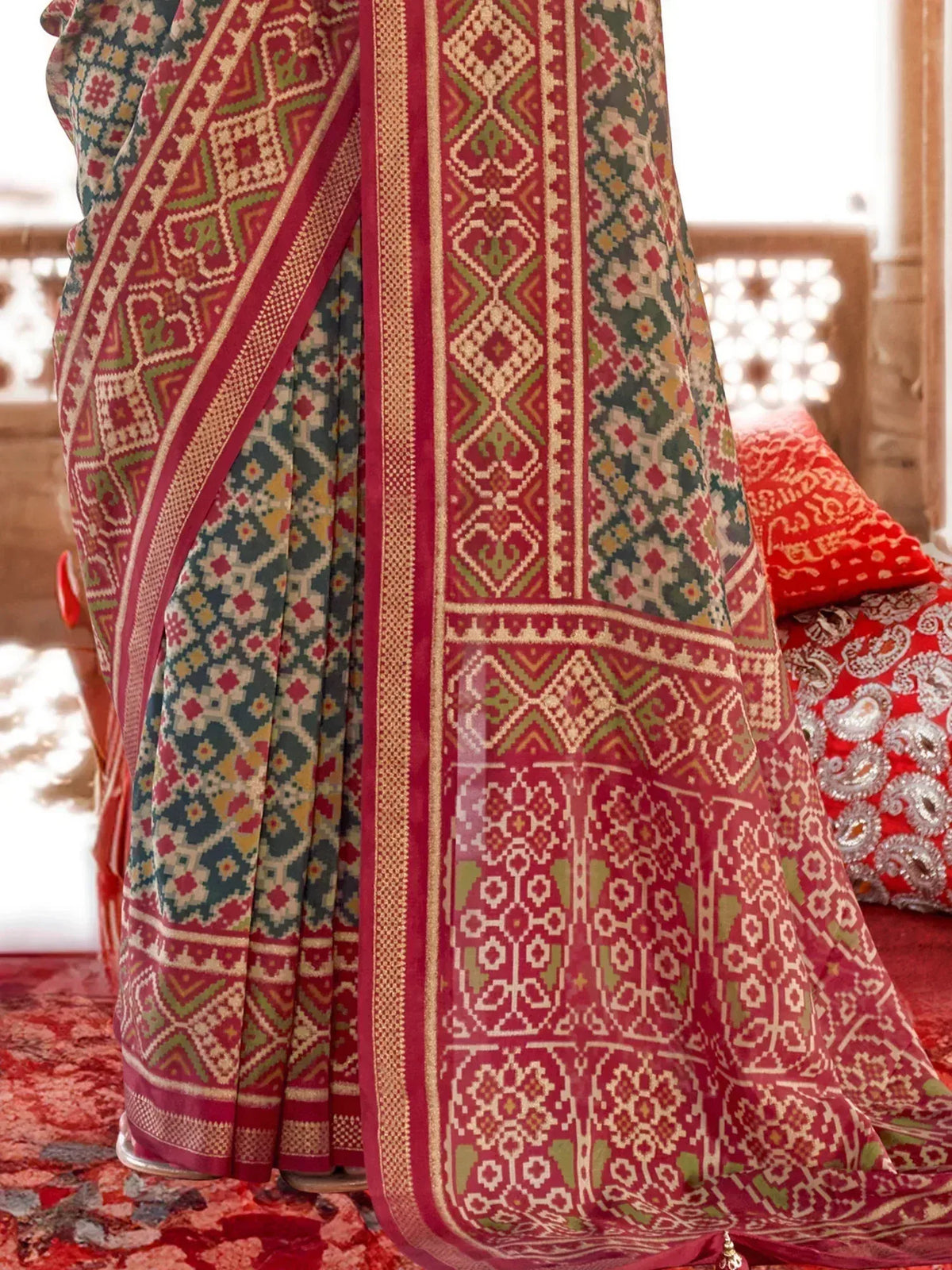 Indian ethnic saree with intricate geometric patterns in red, green, and gold, perfect for festive occasions
