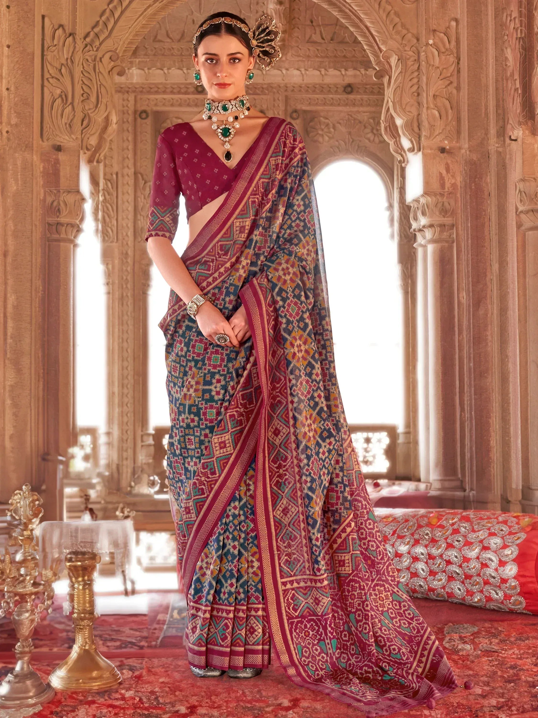 Elegant woman in designer ethnic saree with intricate geometric print, paired with traditional jewelry, perfect for festive occasions.