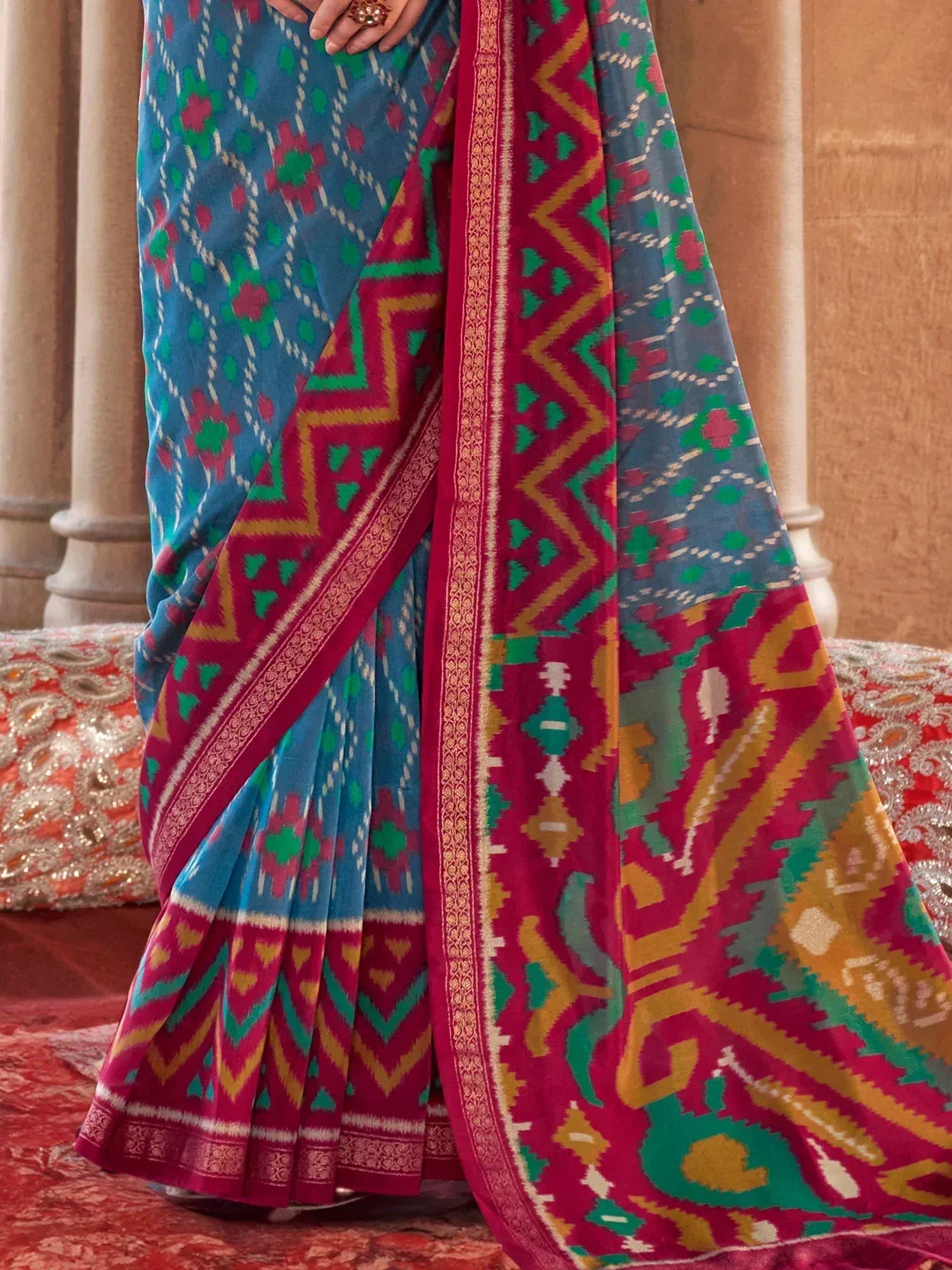 Blue and red Ikat saree with geometric patterns, perfect for ethnic wear occasions