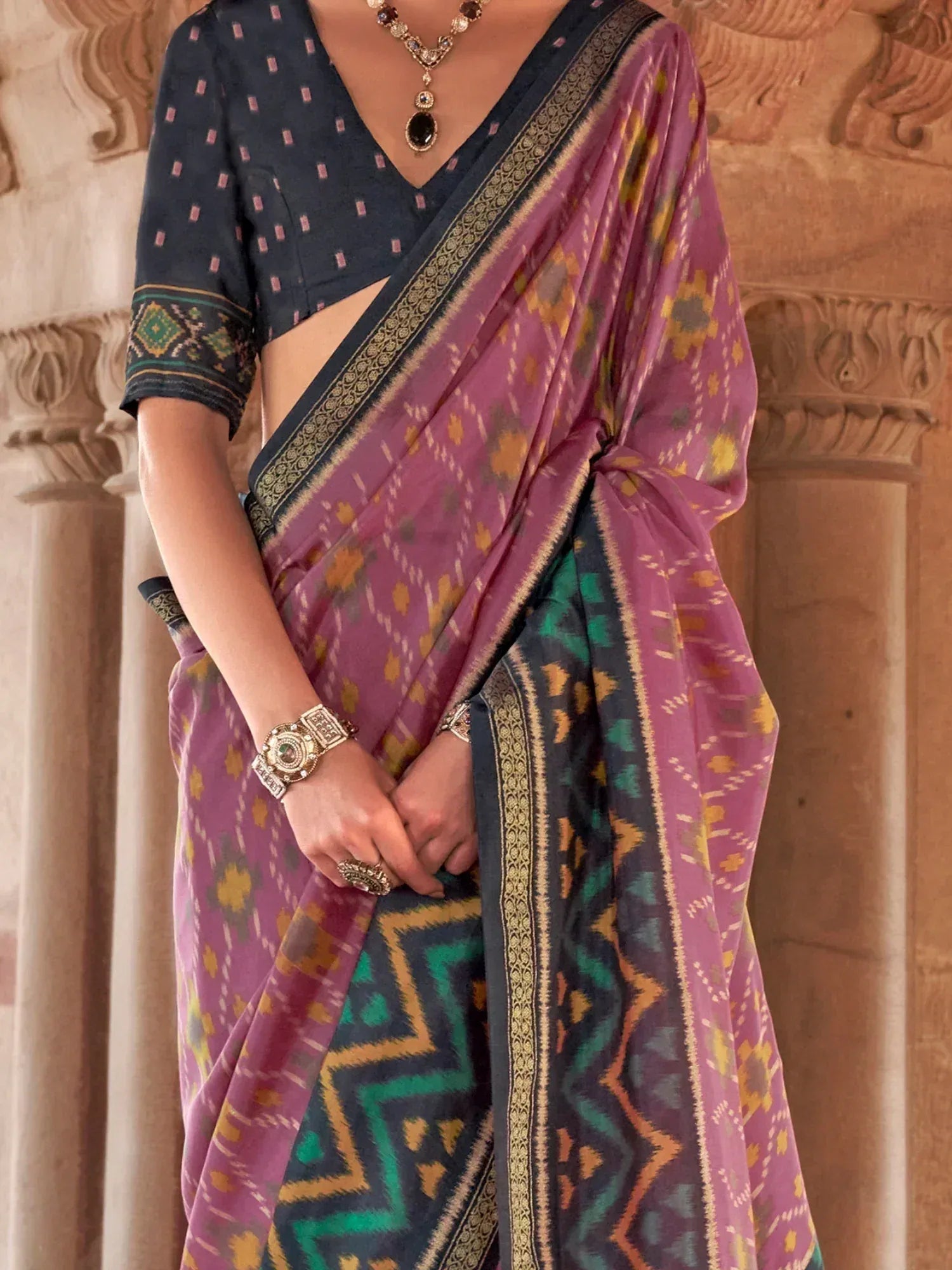 Purple and green ikat saree with geometric print, paired with navy blouse, perfect for Indian ethnic wear