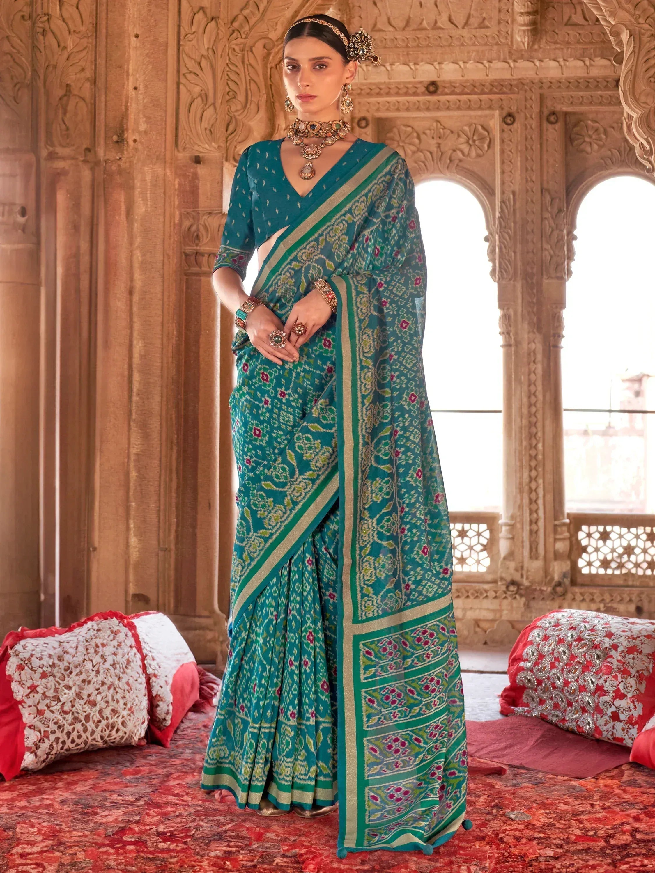 Teal floral print saree with green border, traditional Indian ethnic wear for women, styled with jewelry