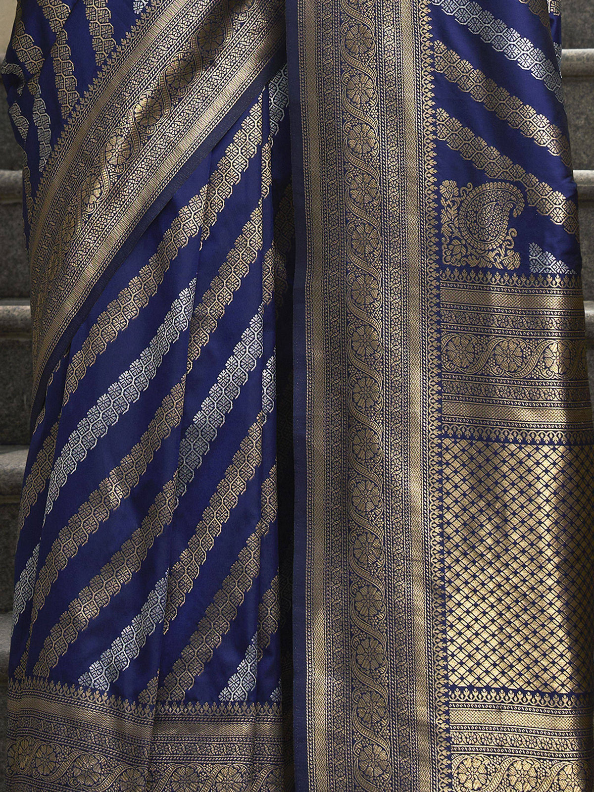 Royal blue saree with intricate gold zari work and traditional paisley motifs, perfect for ethnic occasions.
