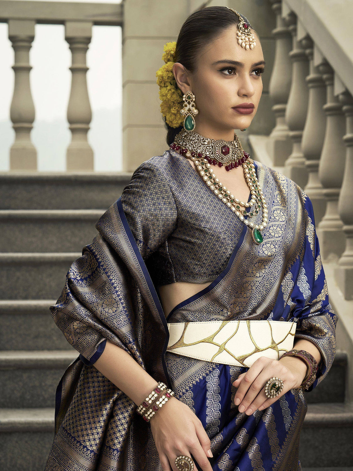 Elegant woman in blue and gold designer saree with traditional jewelry, perfect for Indian ethnic occasions.