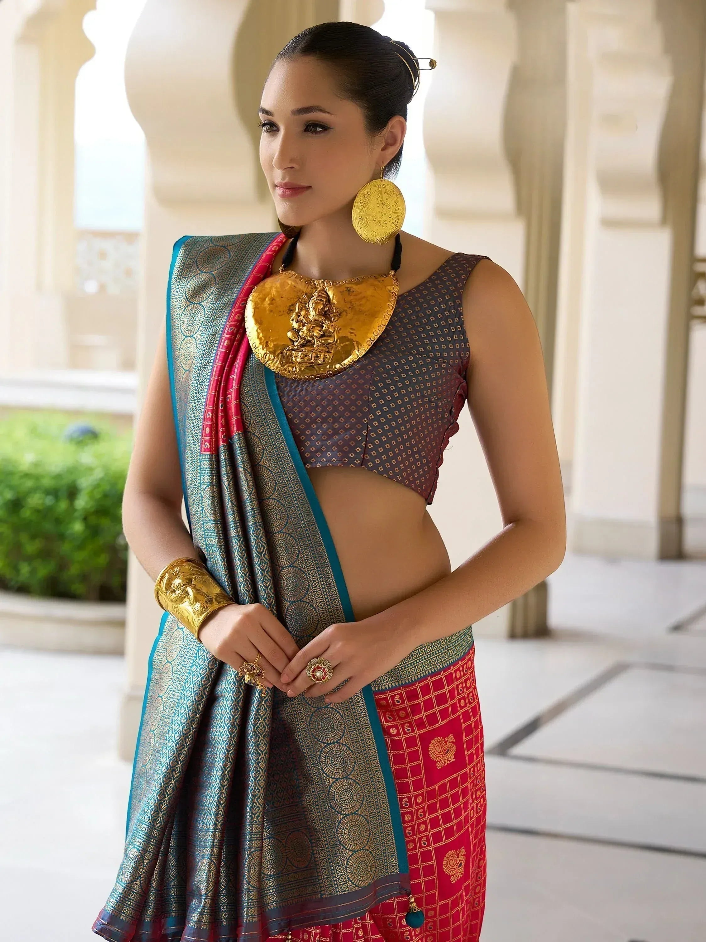 Woman in traditional Indian saree with gold jewelry, ethnic wear for festive occasions