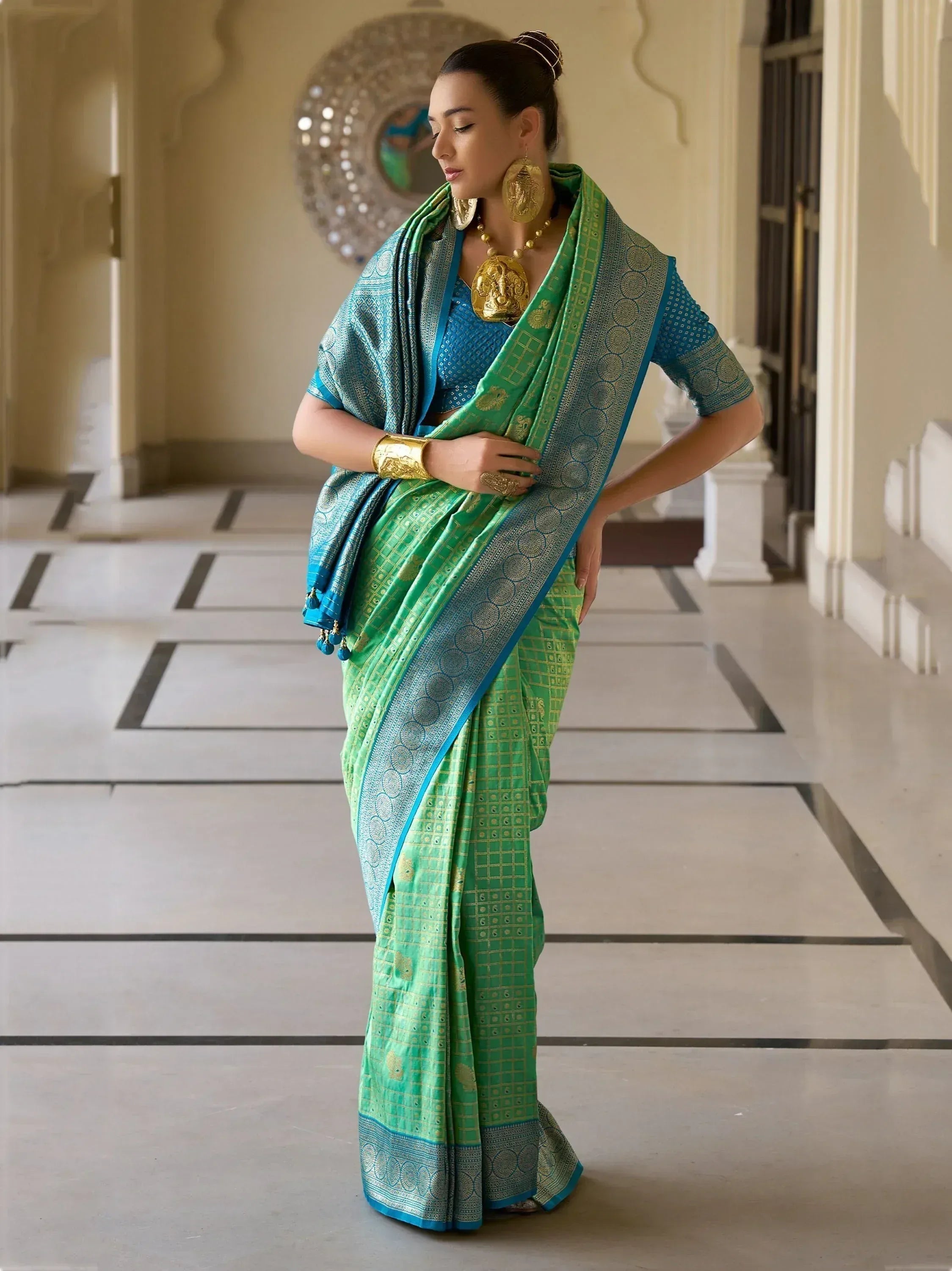 Elegant green and blue designer saree with gold motifs, perfect for Indian ethnic wear occasions