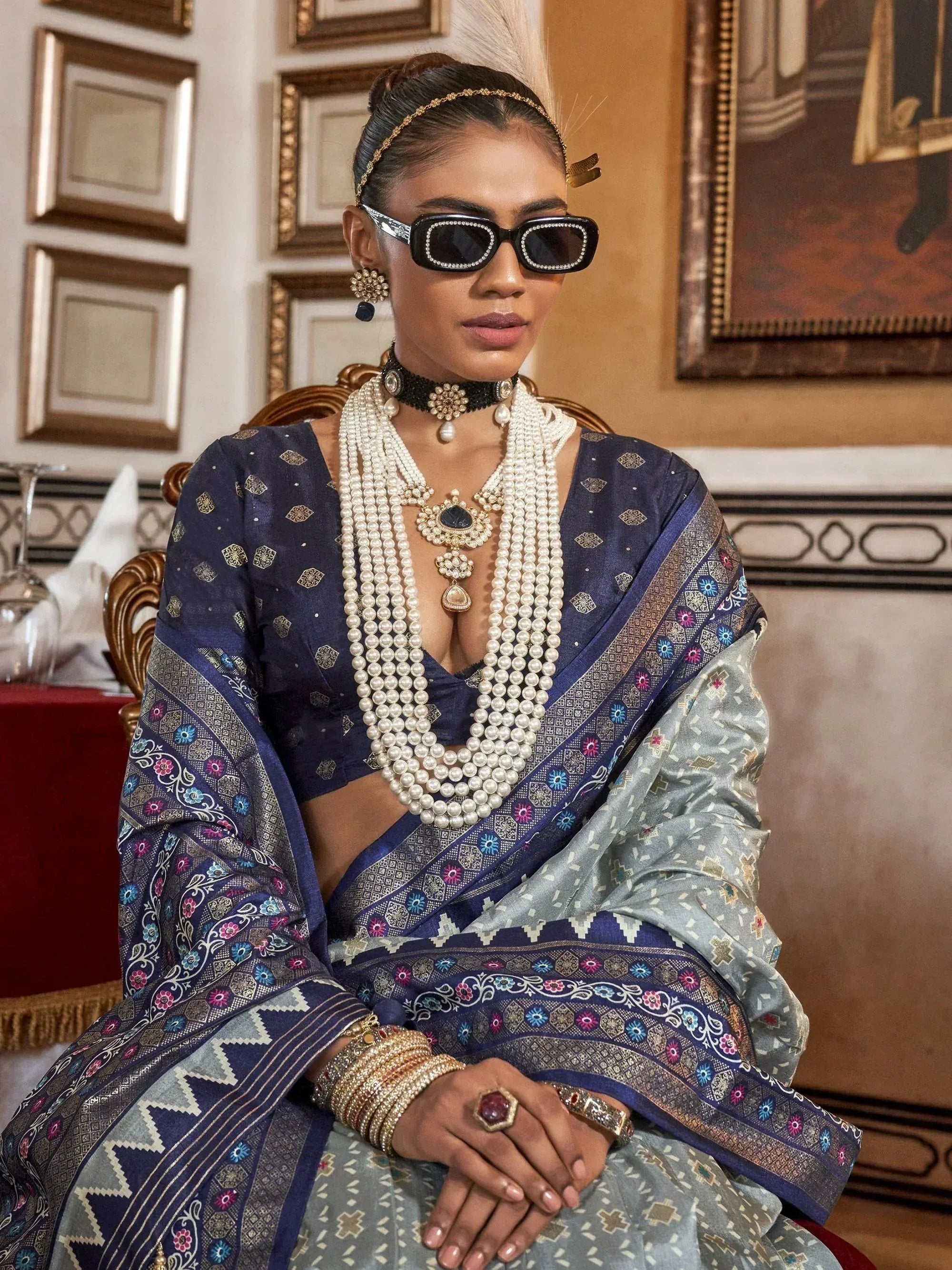 Woman in blue embroidered saree with pearl jewelry and statement sunglasses, Indian ethnic wear