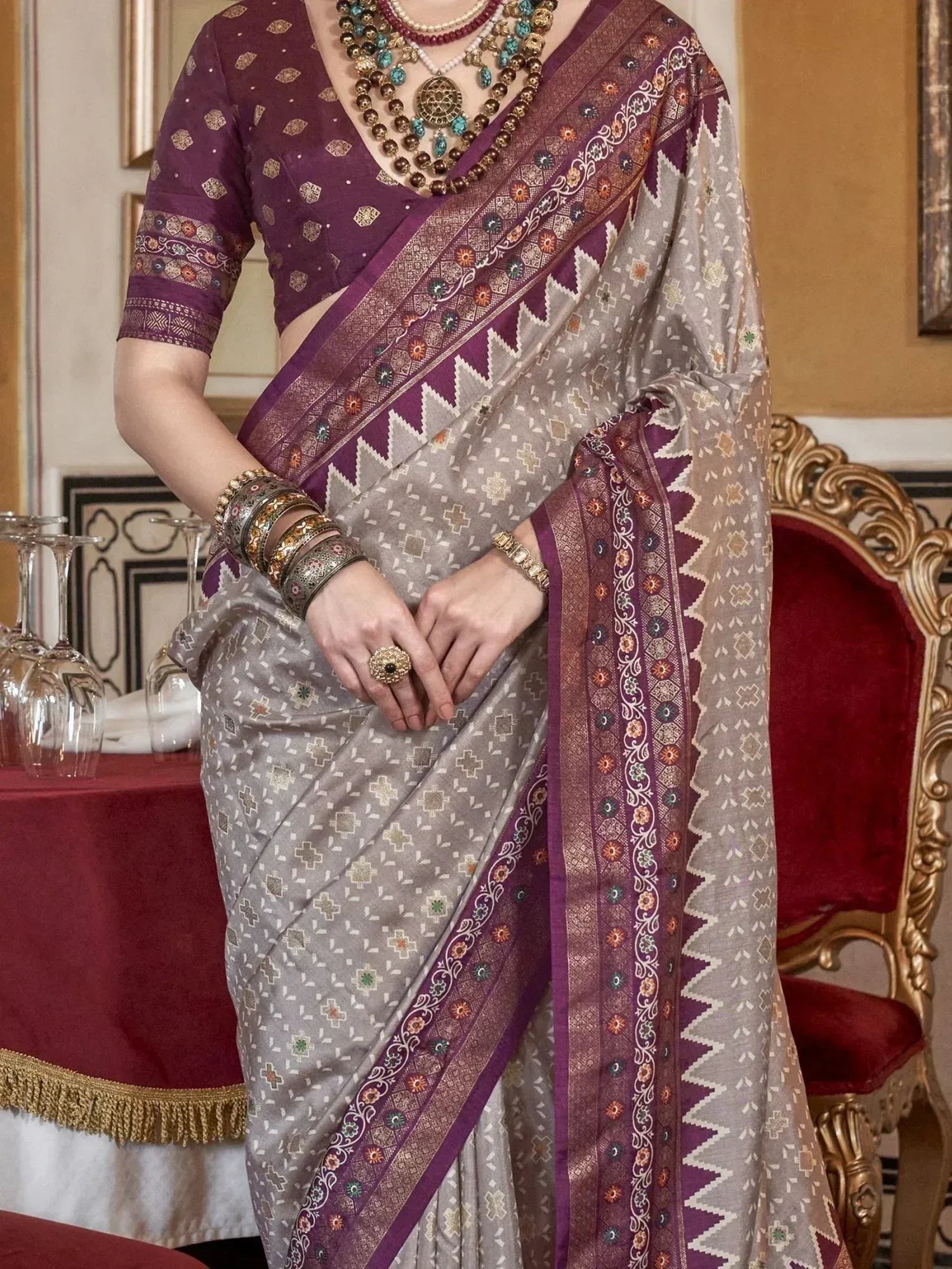 Elegant grey and purple ethnic saree with intricate border, paired with designer blouse and traditional jewelry