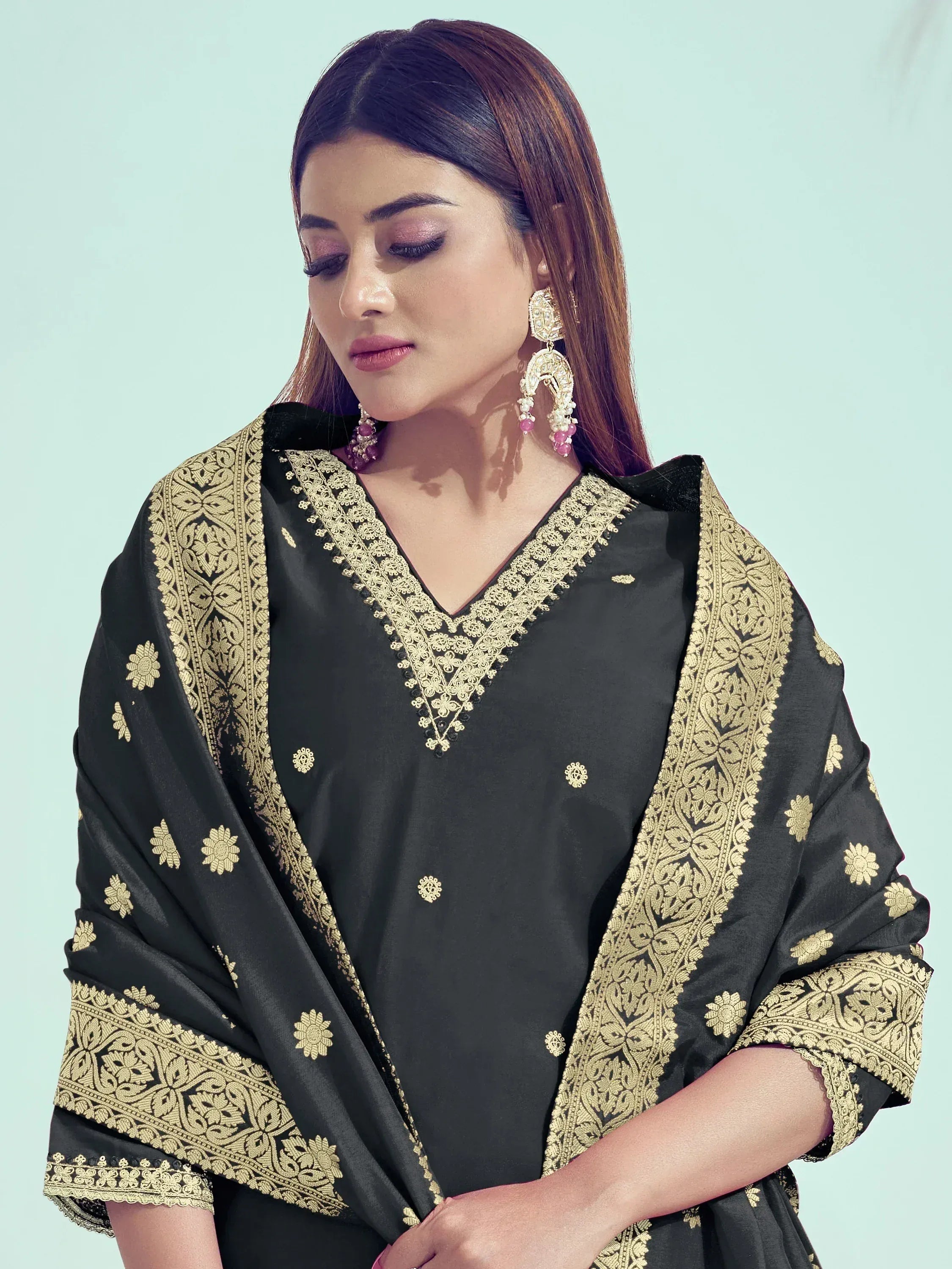 Black ethnic kurti with gold embroidery and matching dupatta, styled with traditional jewelry
