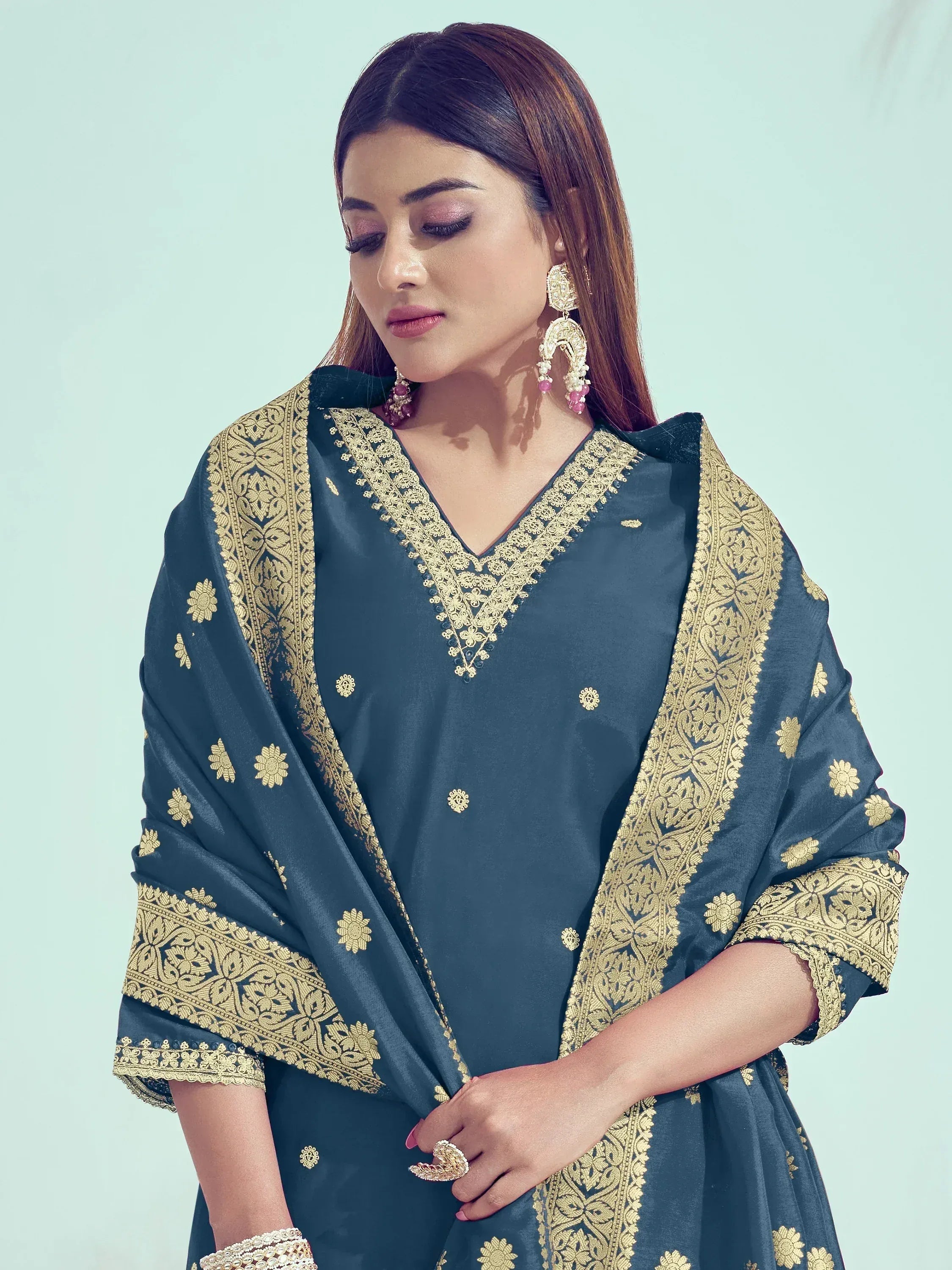 Elegant dark blue ethnic gown with gold embroidery, perfect for Indian festive occasions and weddings.
