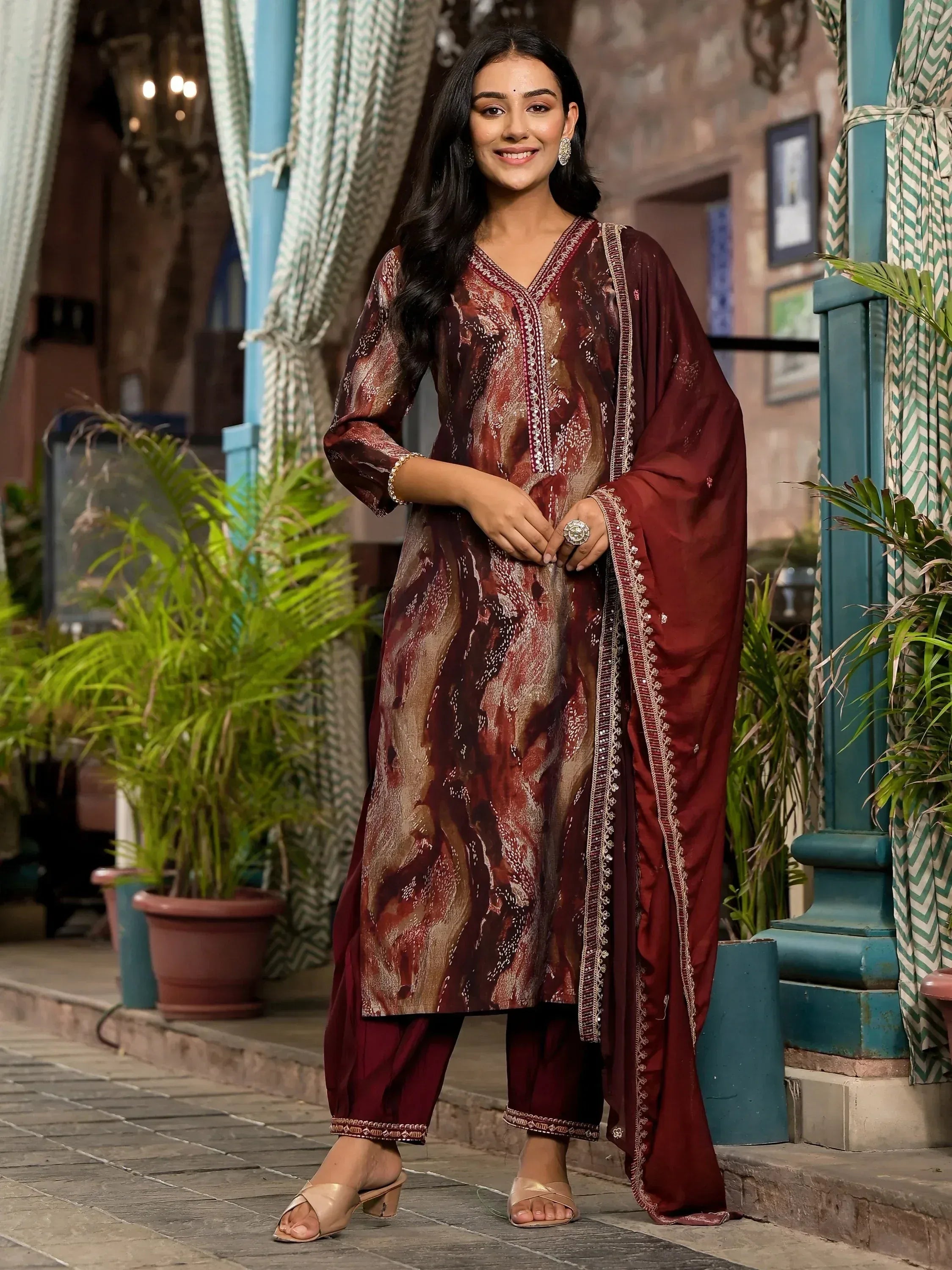Woman in maroon printed salwar kameez with embroidery, ethnic wear for festive occasions