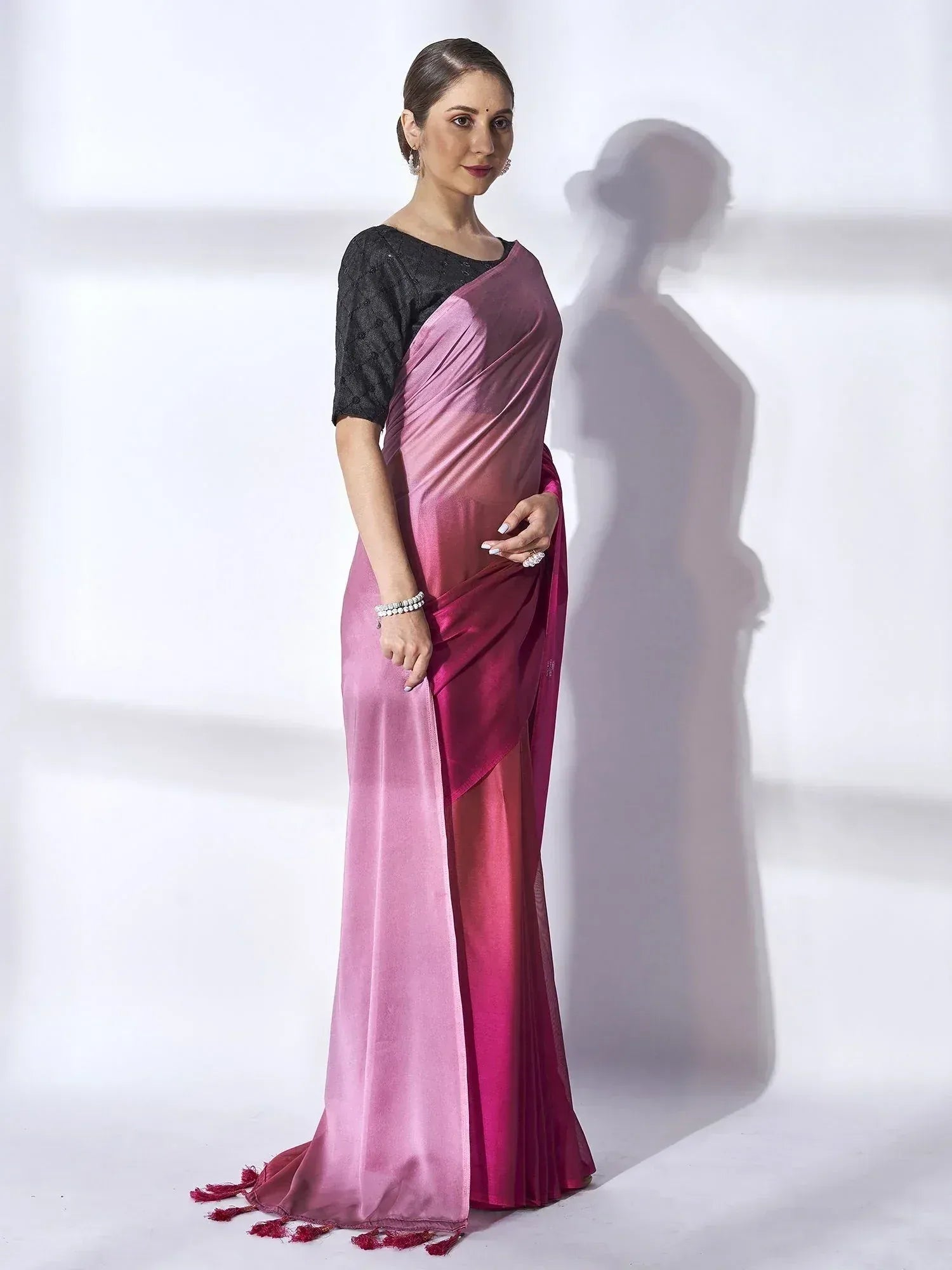 Woman in elegant pink ombre saree with black blouse, perfect for Indian ethnic wear occasions