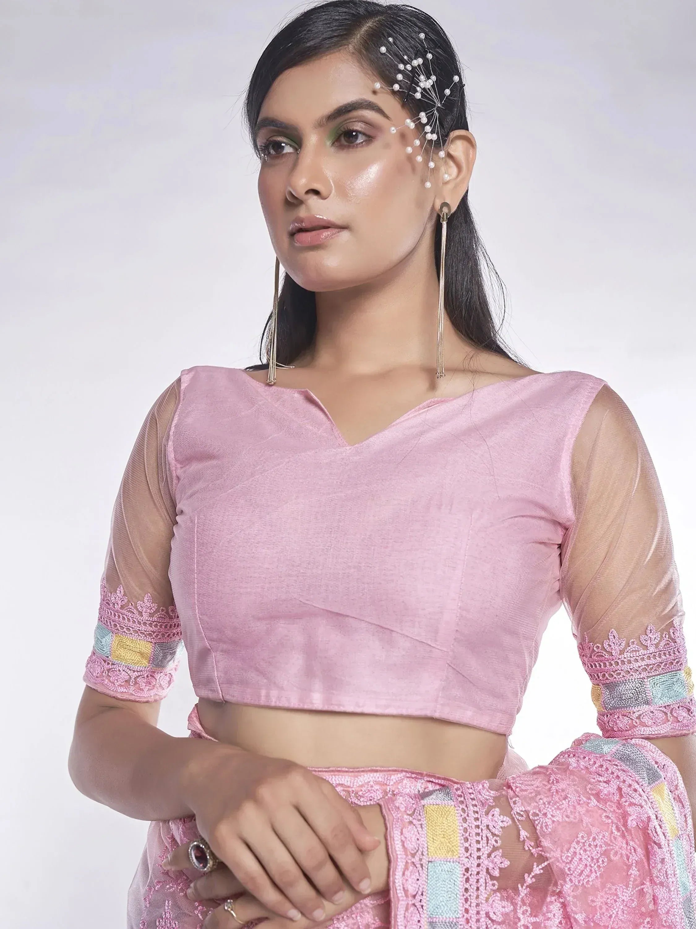 Pink ethnic crop top with sheer sleeves and lace detailing, paired with matching skirt for Indian wear