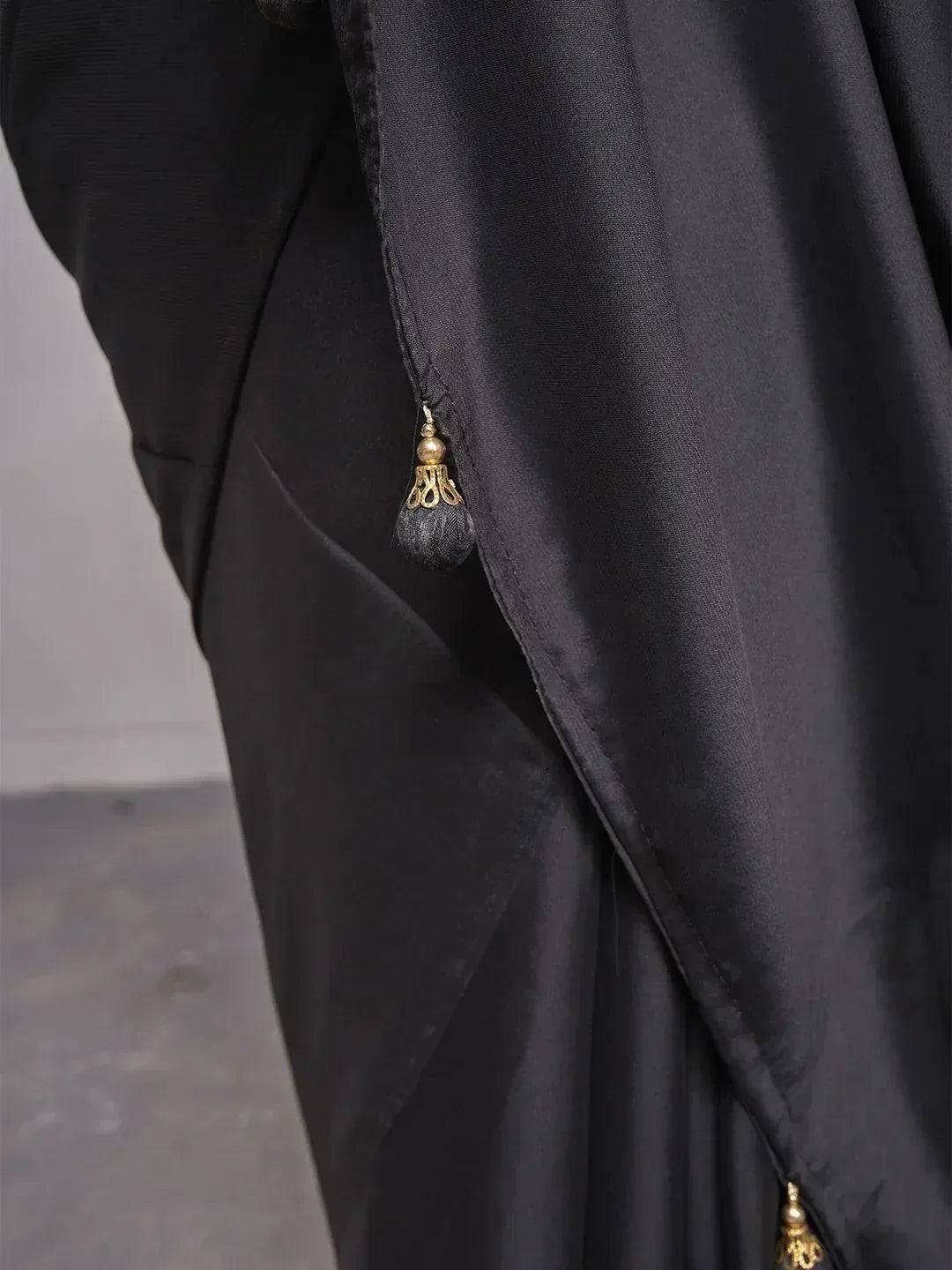 Black ethnic gown with gold tassel detailing, elegant Indian wear for women
