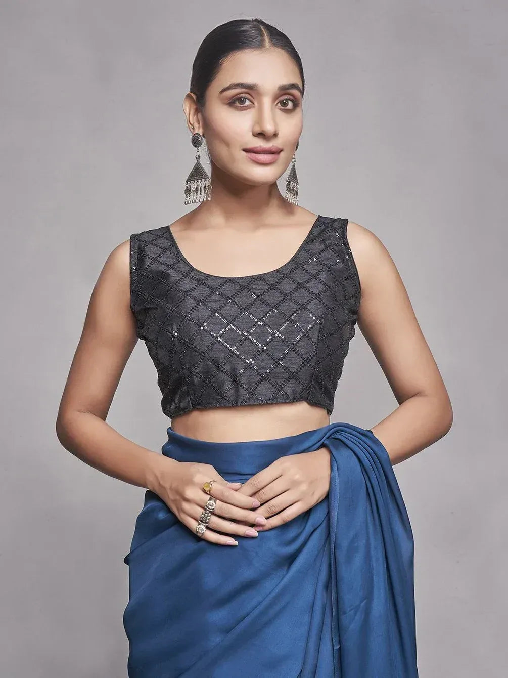 Woman in black sequin blouse with blue saree, ethnic Indian wear